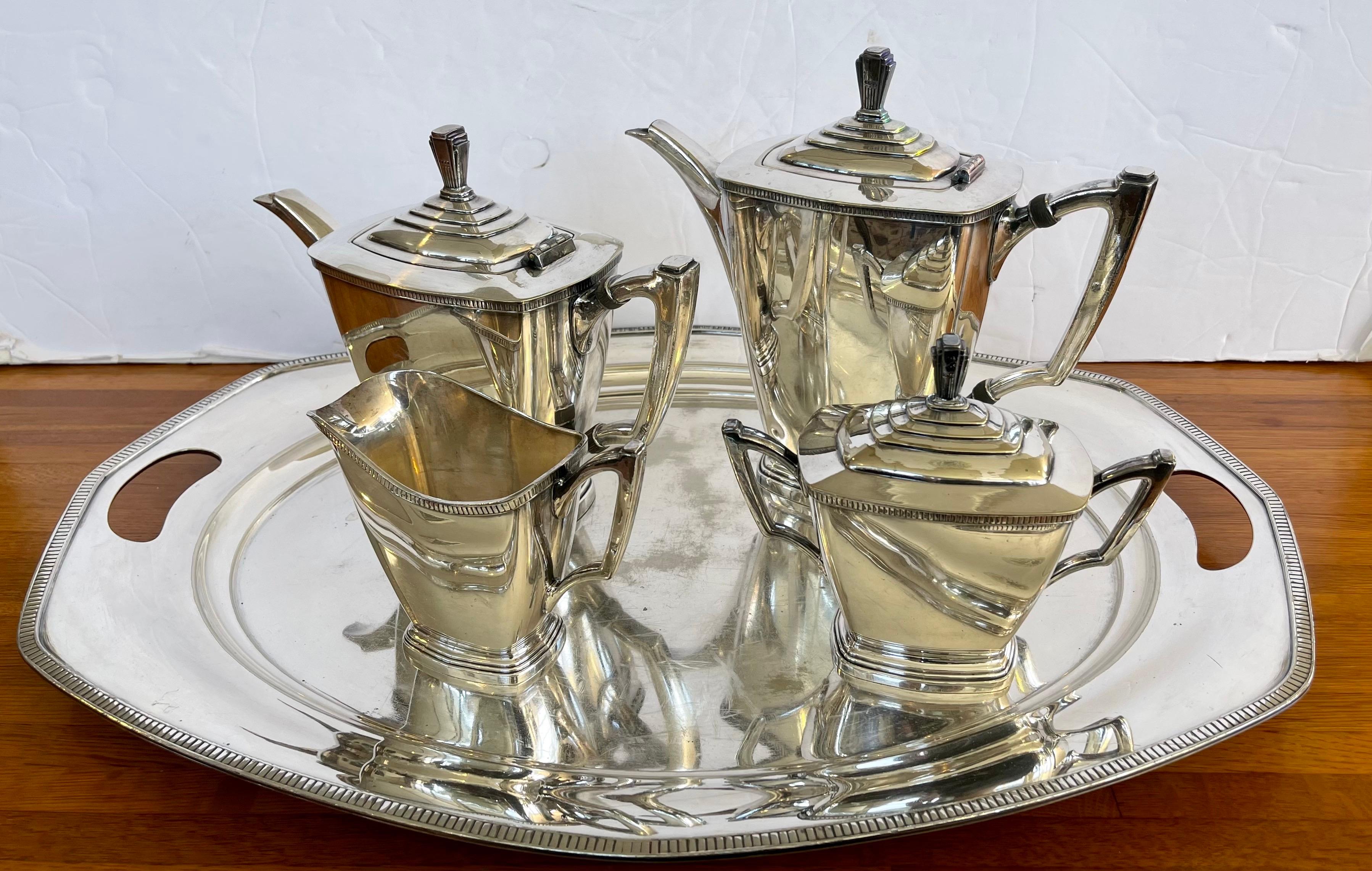 Elegant, mid twentieth century Art Deco style silver (not sterling) tea set by Wallace Silversmiths. No monograms. Stylish and sleek with matching tray that has hollowed handles. Would benefit from a nice polish but spectacular otherwise. The Art