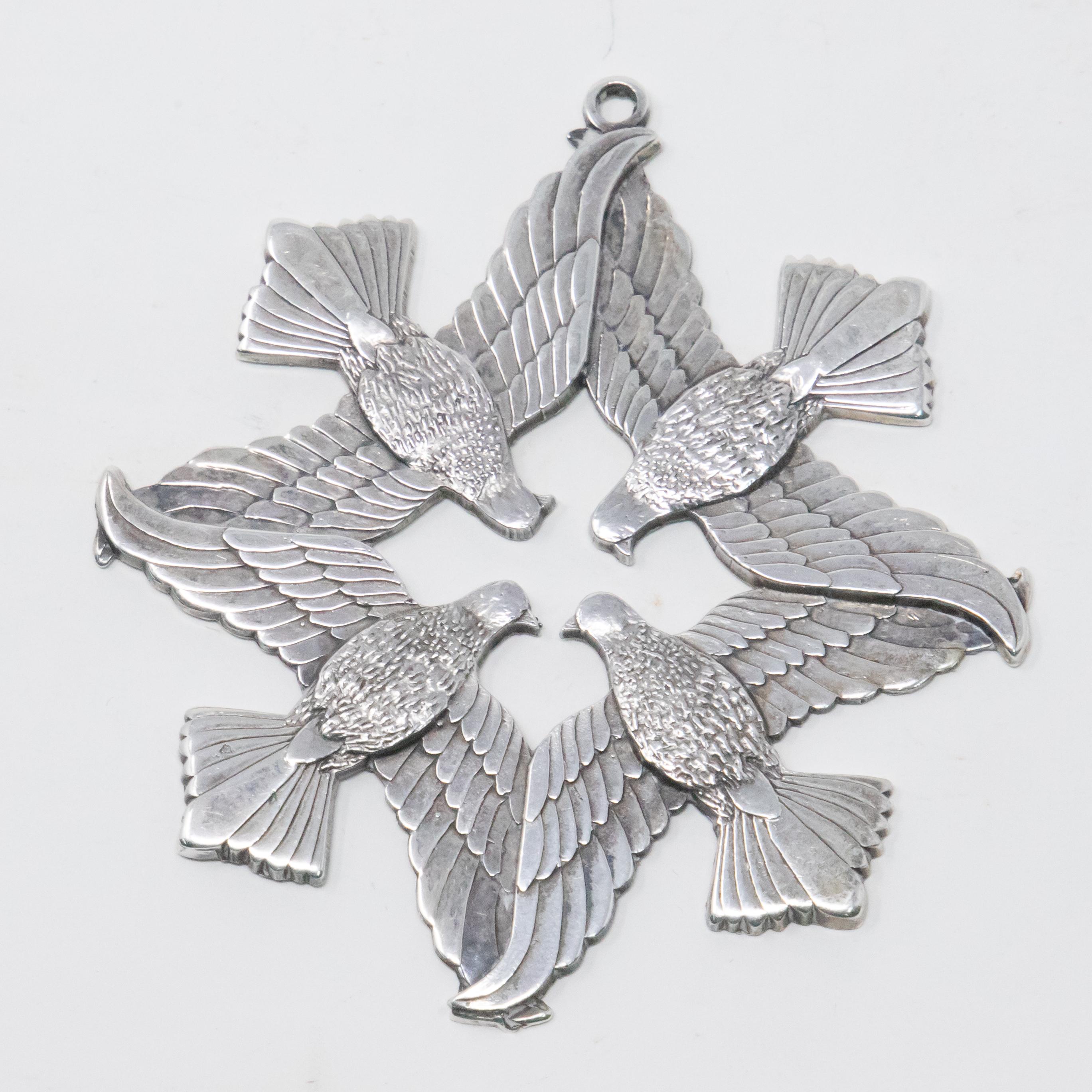 Offering this stunning Wallace sterling ornament from 1971. With an open center starting and four heads of birds. From there in a geometric pattern the wings go out overlapping one another and then finally the tails. On the back there is a circle