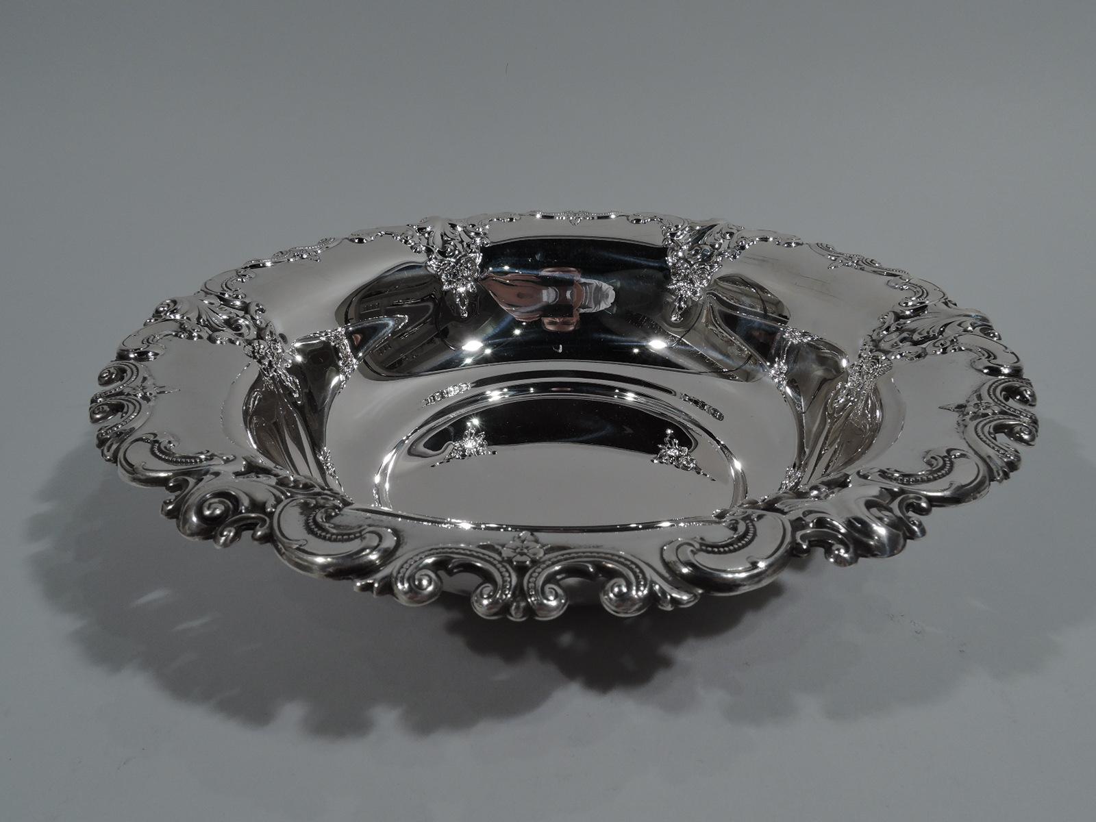 Sterling silver serving bowl in Grande Baroque. Made by Wallace in Wallingford, Conn. Deep and round with irregular scrolled rim and pendant flower bunches. A great hollowware piece in the Classic pattern. Fully marked including maker’s stamp,