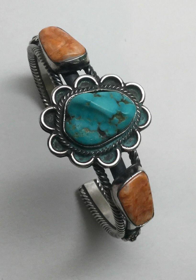 Wallace Yazzie Jr. Navajo Sterling silver turquoise and spiny oyster cuff bracelet.

Marked: Wallace Jr. STERLING

Measures 6 1/4
