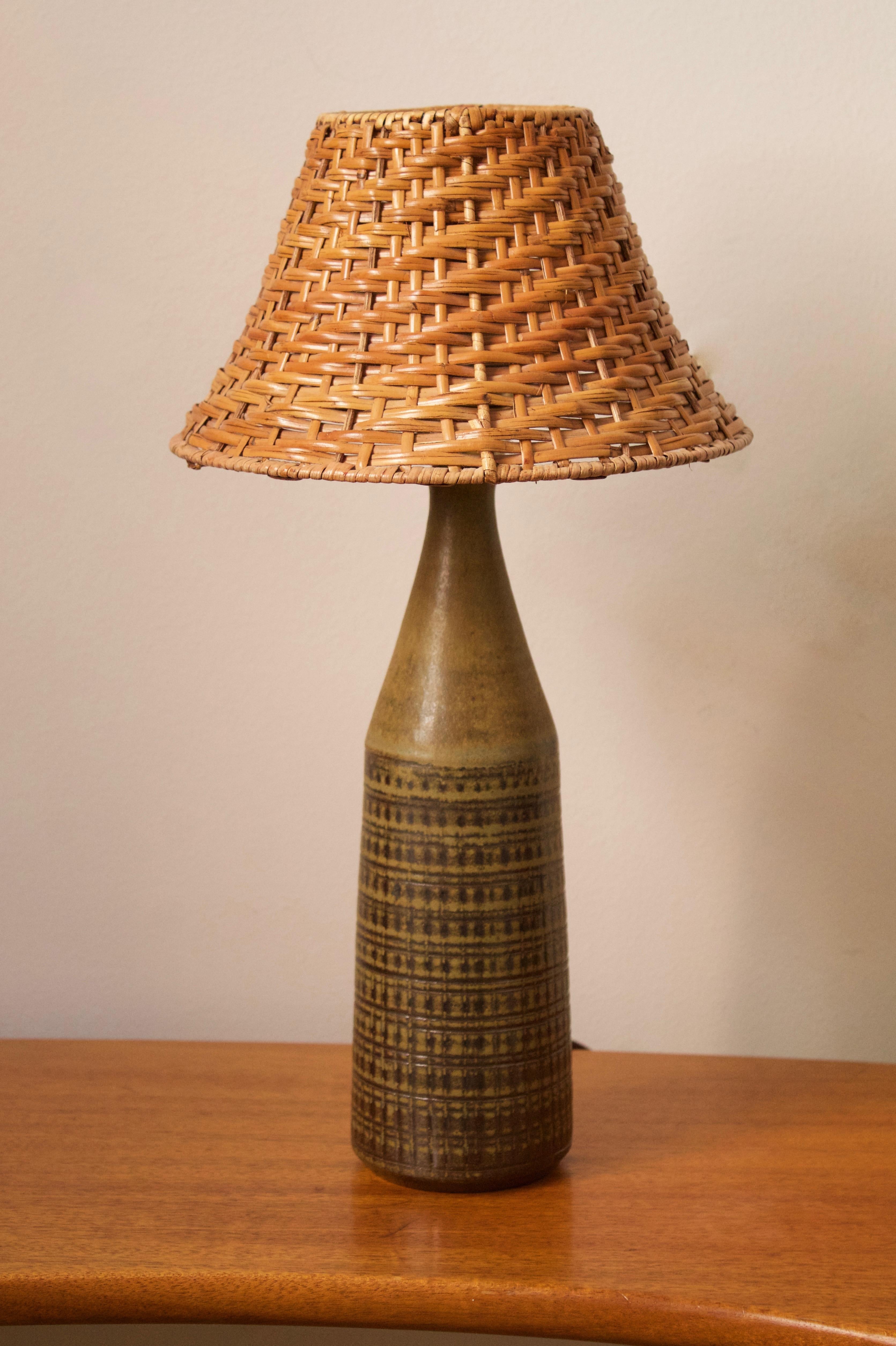 A table lamp. Designed and produced by Wallåkra, Sweden, 1960s. Features simple hand-painted and incised decoration.

Stated dimensions exclude lampshade. Height includes socket. Upon request illustrated lampshade can be included in purchase.