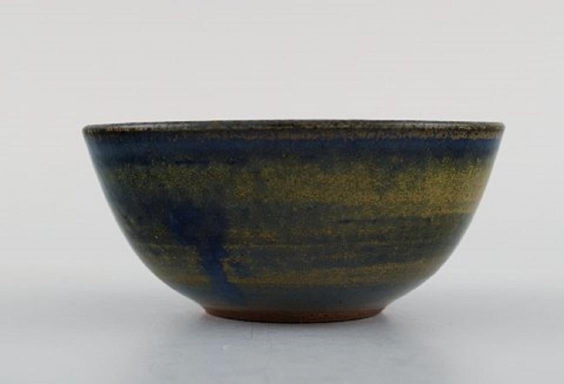 Wallåkra, Sweden. Bowl in glazed ceramics. Beautiful glaze in blue and light earth shades, 1960s.
Measures: 11.3 x 5 cm.
Stamped.
In excellent condition.