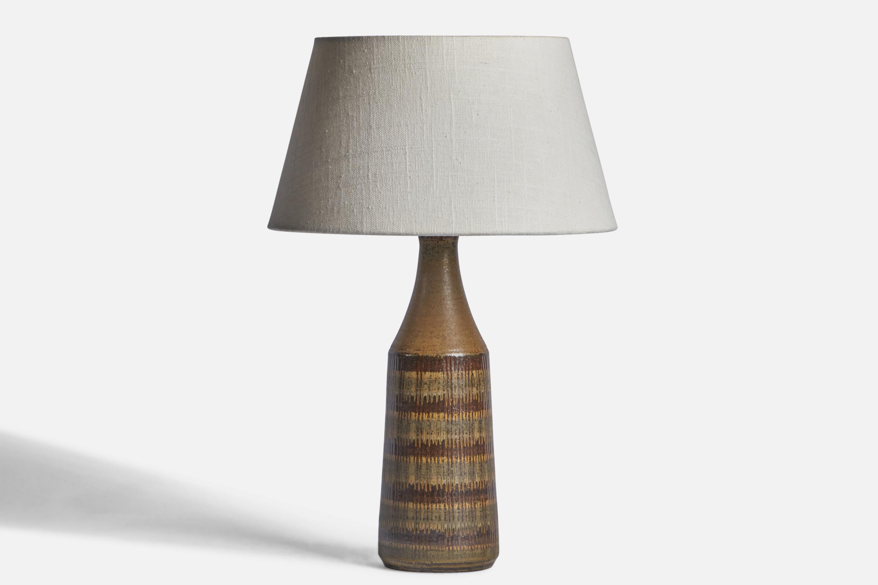 A brown-glazed stoneware table lamp designed and produced by Wallåkra, Sweden, 1950s.

Dimensions of Lamp (inches): 11.95” H x 3.5” Diameter
Dimensions of Shade (inches): 7” Top Diameter x 10” Bottom Diameter x 5.5” H 
Dimensions of Lamp with Shade