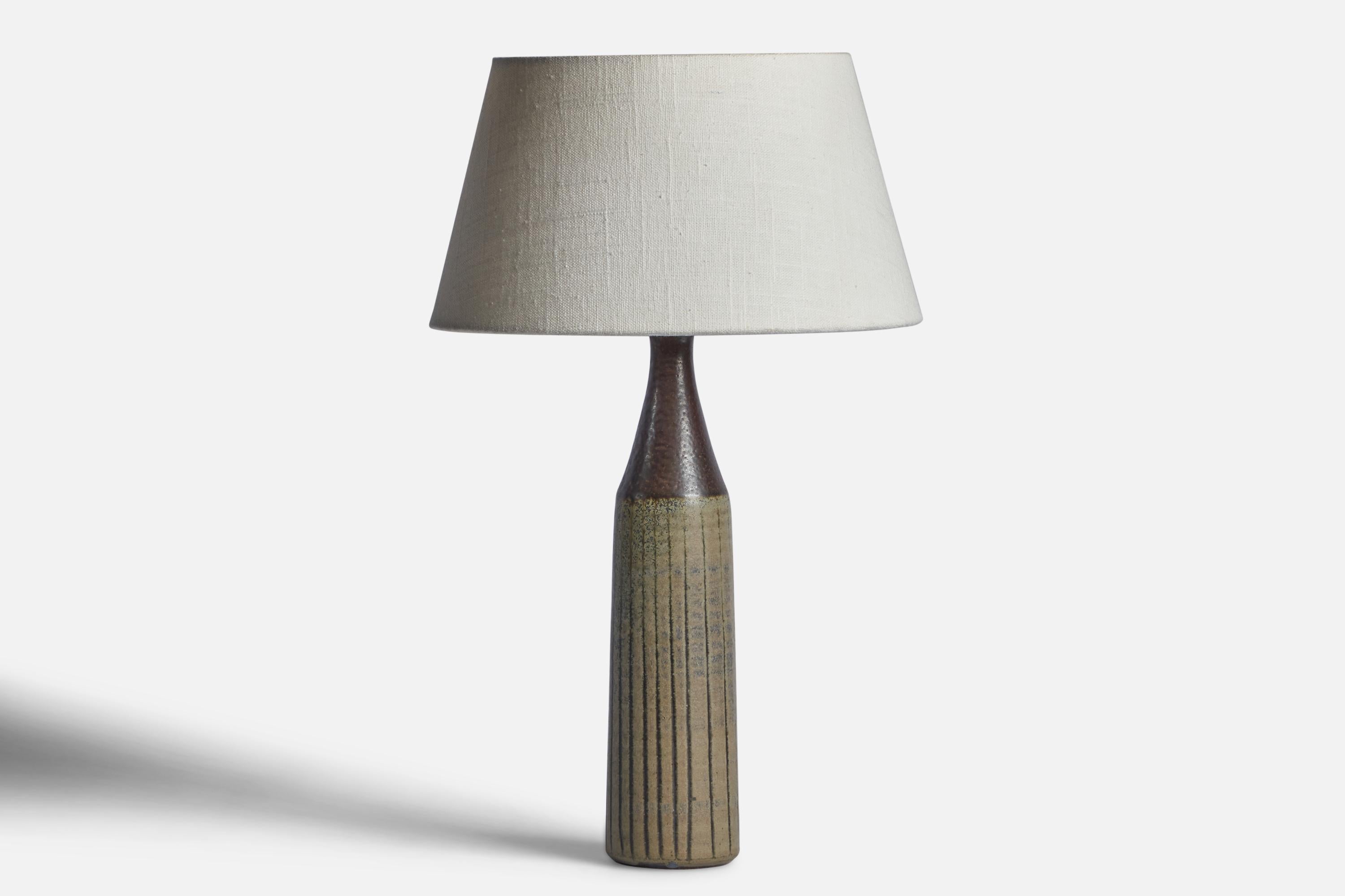 A grey and green-glazed stoneware table lamp designed and produced by Wallåkra, Sweden, c. 1950s.

Dimensions of Lamp (inches): 13.25” H x 2.75” Diameter
Dimensions of Shade (inches): 7” Top Diameter x 10” Bottom Diameter x 5.5” H 
Dimensions of