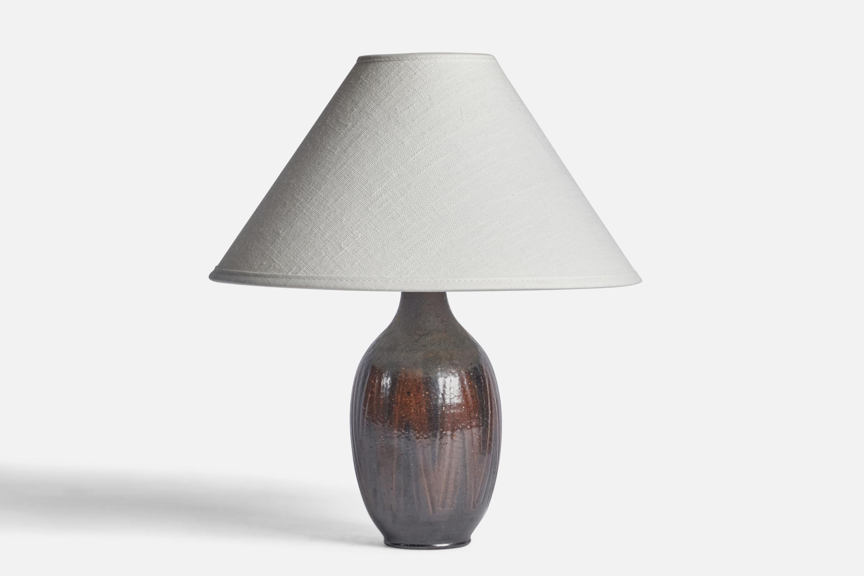 A brown and black-glazed table lamp designed and produced by Wallåkra, Sweden, c. 1960s.

Dimensions of Lamp (inches): 8.25” H x 3.5” Diameter
Dimensions of Shade (inches): 2.5” Top Diameter x 10” Bottom Diameter x 5.5