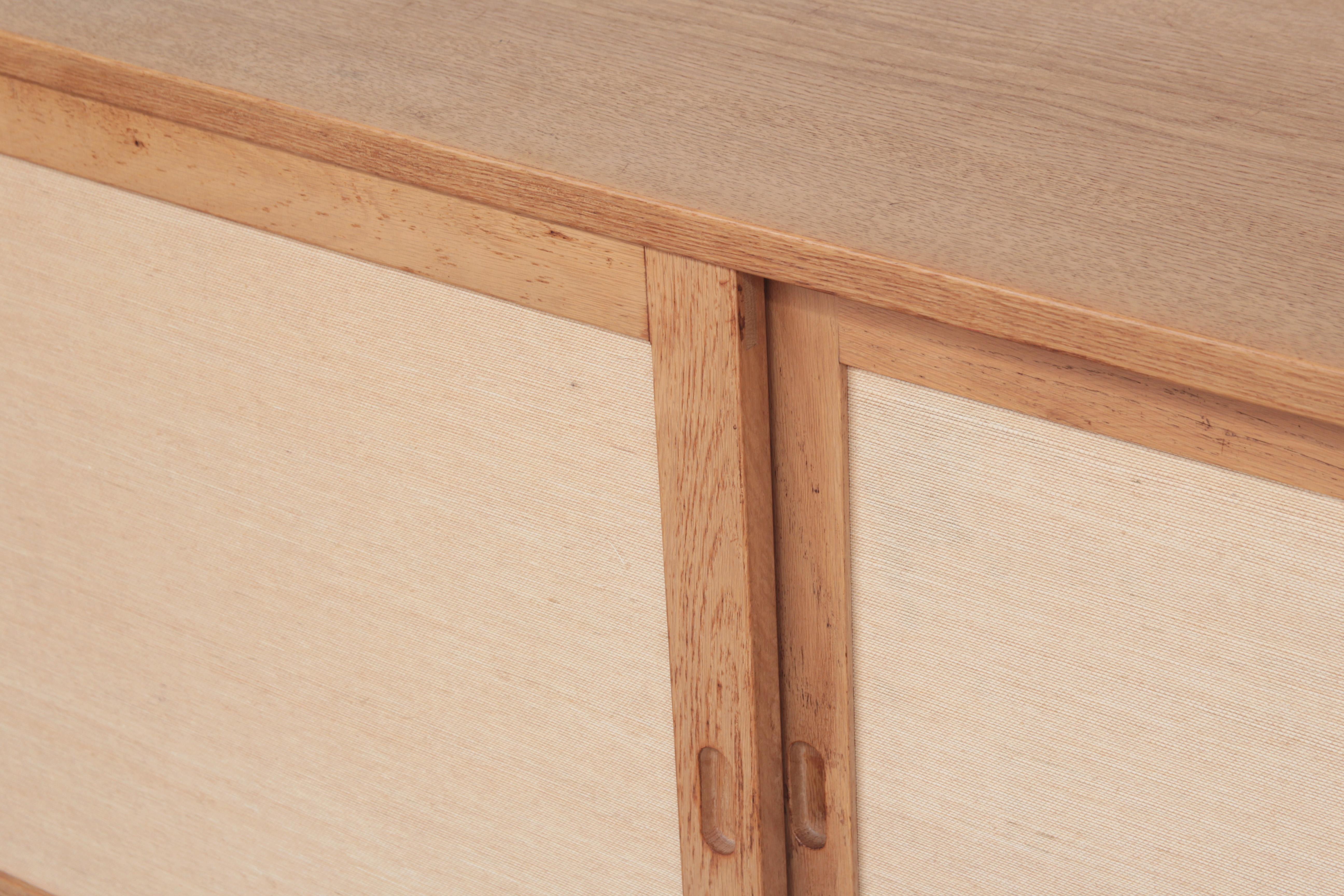 Very beautiful sideboard designed by Børge Mogensen for Karl Andersson & Söhne in the 1960s.
It is made of oak wood, cane is still in a wonderful condition with just little traces of usage.