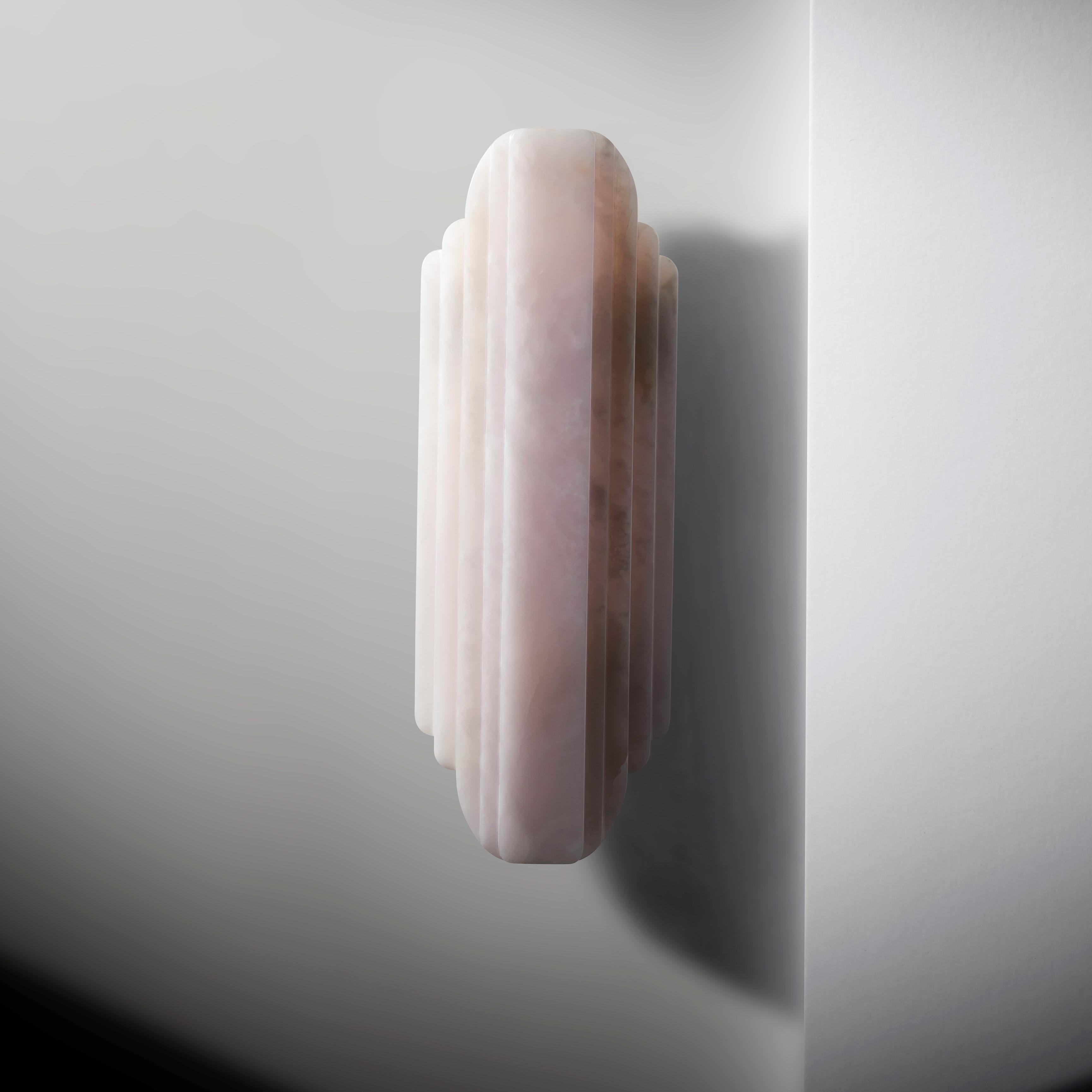 Walljewel by Lisette Rützou
Dimensions: 15 x H 42 cm
Materials: Rose, Green and White Onyx

 Lisette Rützou’s design is motivated by an urge to articulate a story. Inspired by the beauty of materials, form and architecture, each design is an