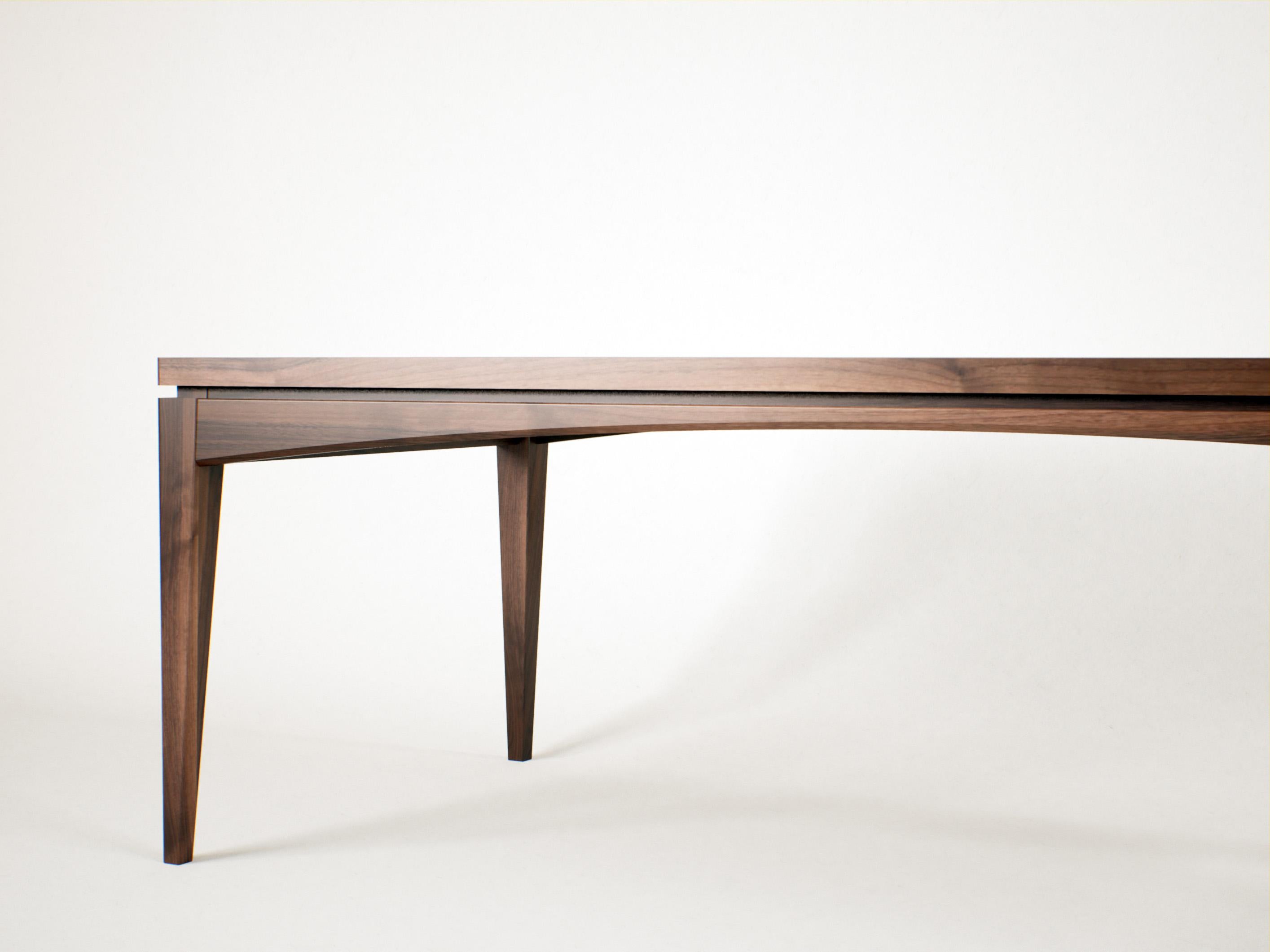 Dining Table in Solid Wood with Geometric Silhouette and Sculptural Presence

This handmade dining table blends minimalist geometry with a grounded, architectural stance. Its structure is defined by the interplay of clean planes and solid volumes,
