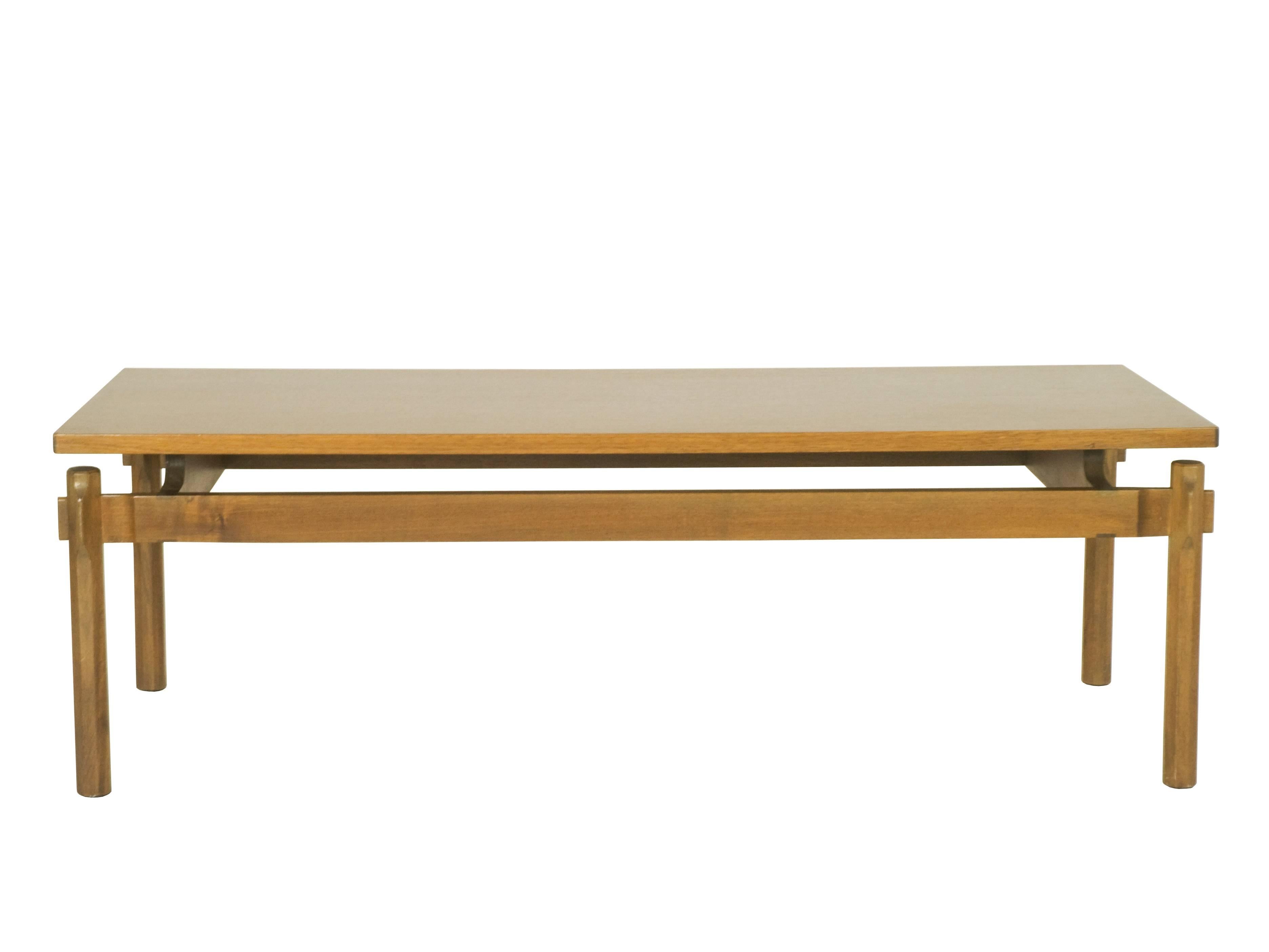 Rare walnut coffee table designed by Ico Parisi and produced by Cassina (Meda, Italy) in the 1960. The tabletop is separated from the legs by two of the four horizontal slats, the carved shape of which makes them taller than their counterparts. The