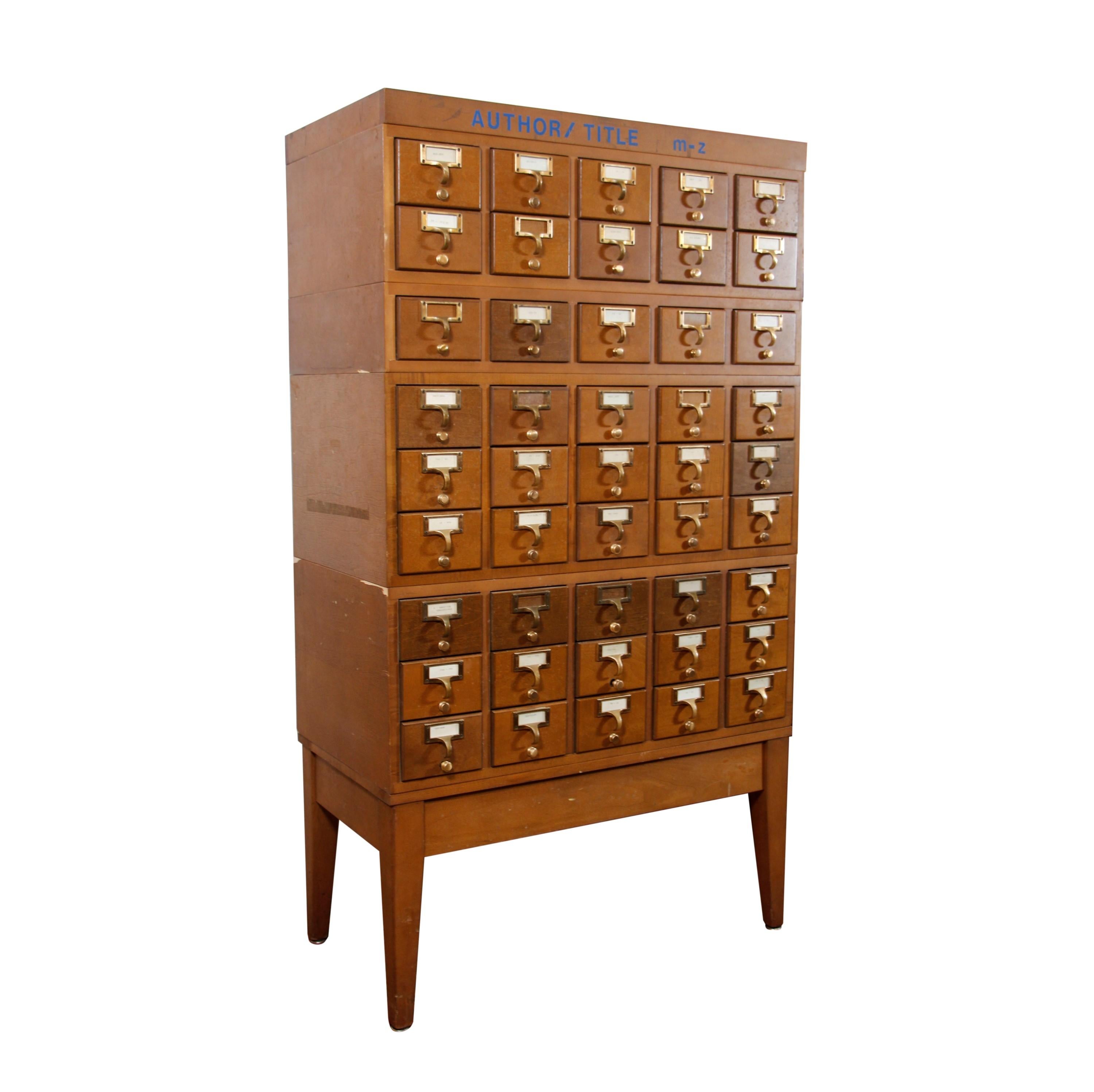 20th century library card cabinet. Each of the 45 drawers is sized to hold 3x5 file cards. Brass finished drawer pulls. Modular construction. Many small chips. Please see images. Please note, this item is located in one of our NYC locations.