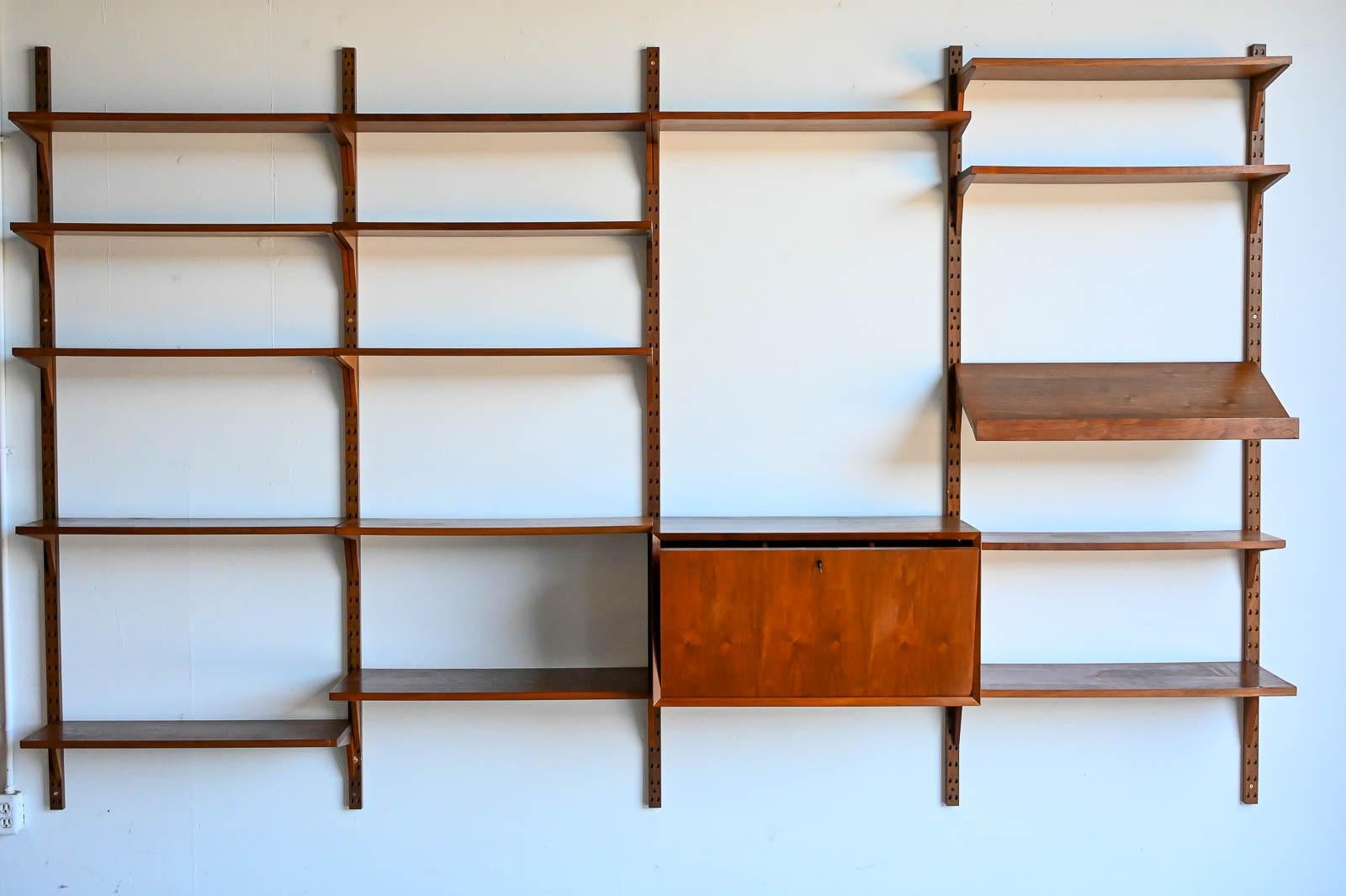 Walnut 4 Bay Poul Cadovius wall unit, ca. 1962. Beautiful walnut shelves and brackets with walnut supports. From original owner in good condition. Can be configured any way you like. Everything included as shown, including original metal bookends