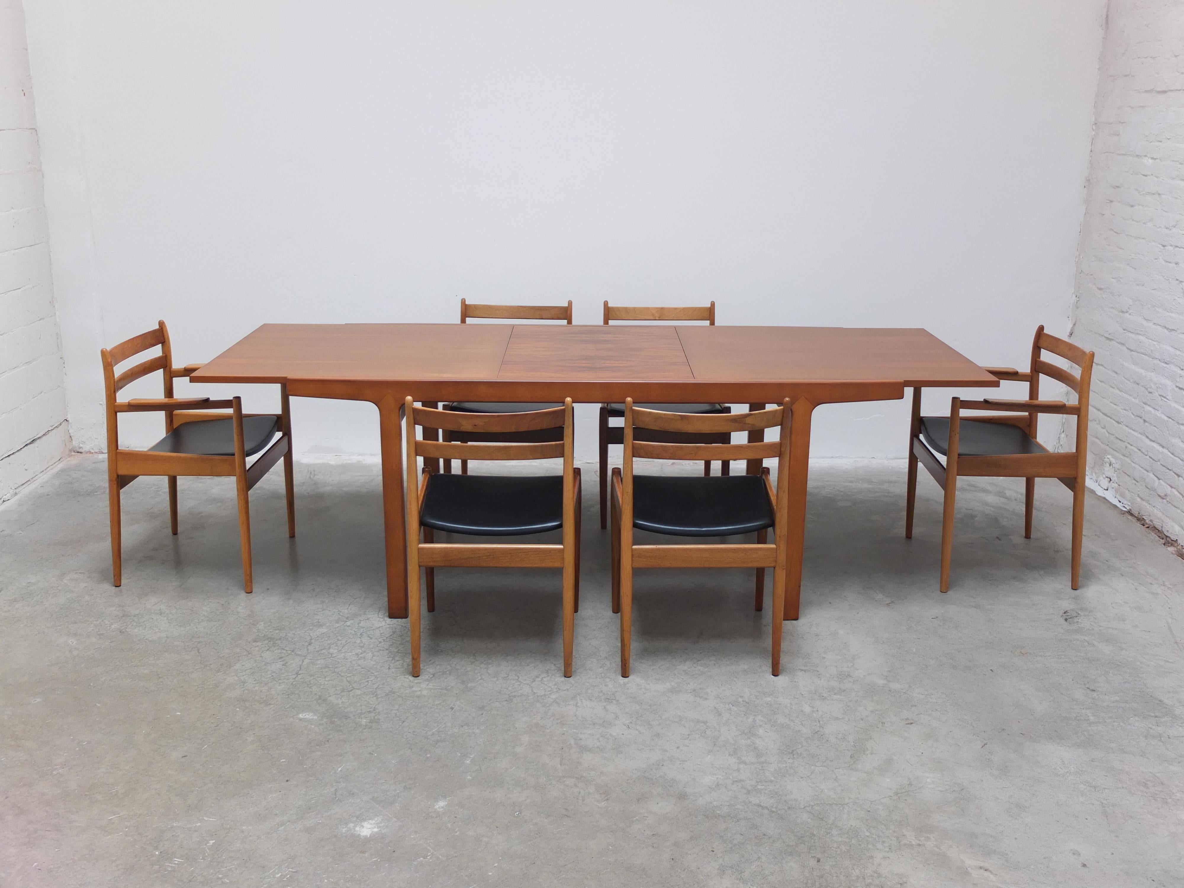 Fantastic dining set from the ‘Abtracta’ series designed by Jos De Mey for Van Den Berghe-Pauvers during the 1960s. This set consists of a large extendable dining table and 6 matching chairs all made of walnut with a very decorative wood grain. The