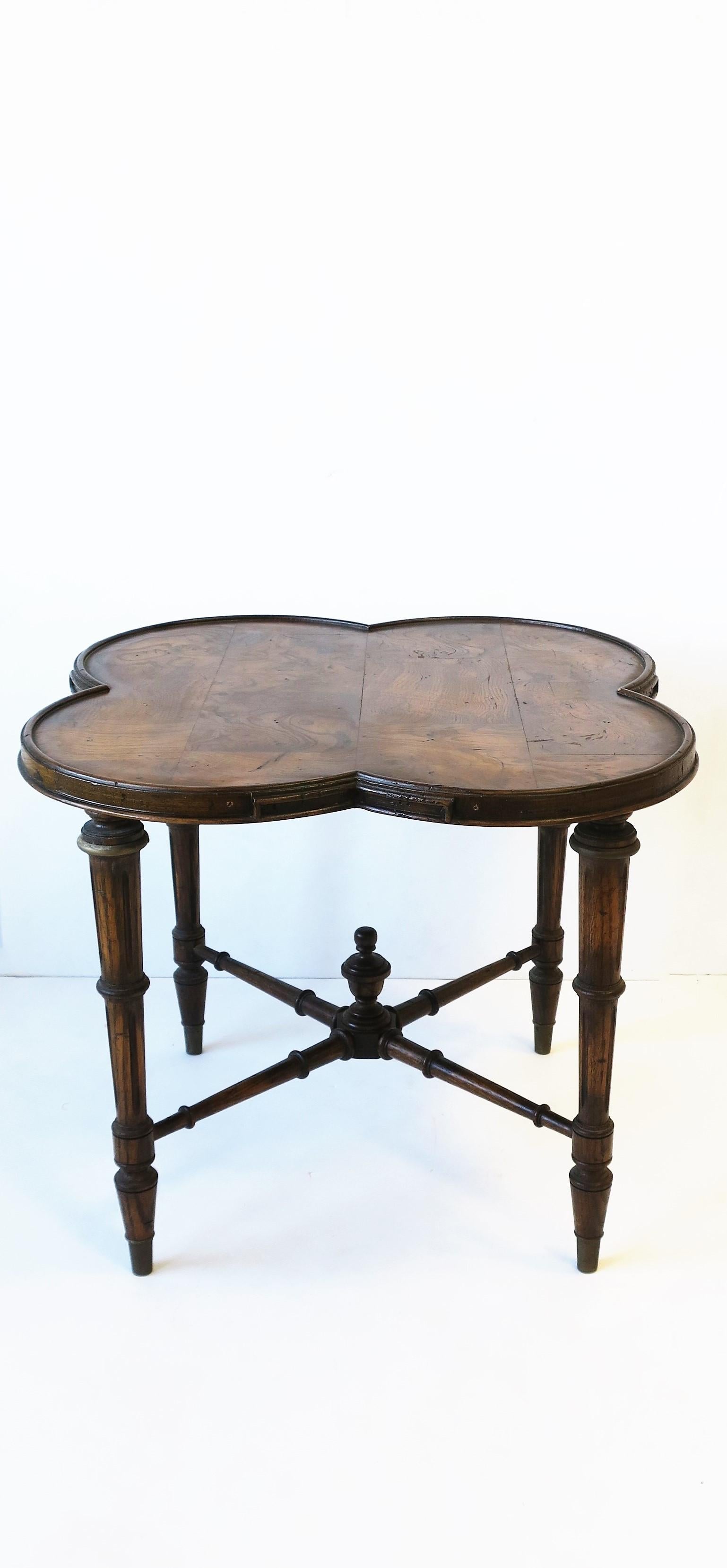 A beautiful burled walnut wood end table with an Alhambra clover top, detailed legs, and stretcher base finish with a carved finial, circa mid-20th century or earlier, Europe. Table can site in two positions as demonstrated in images.
