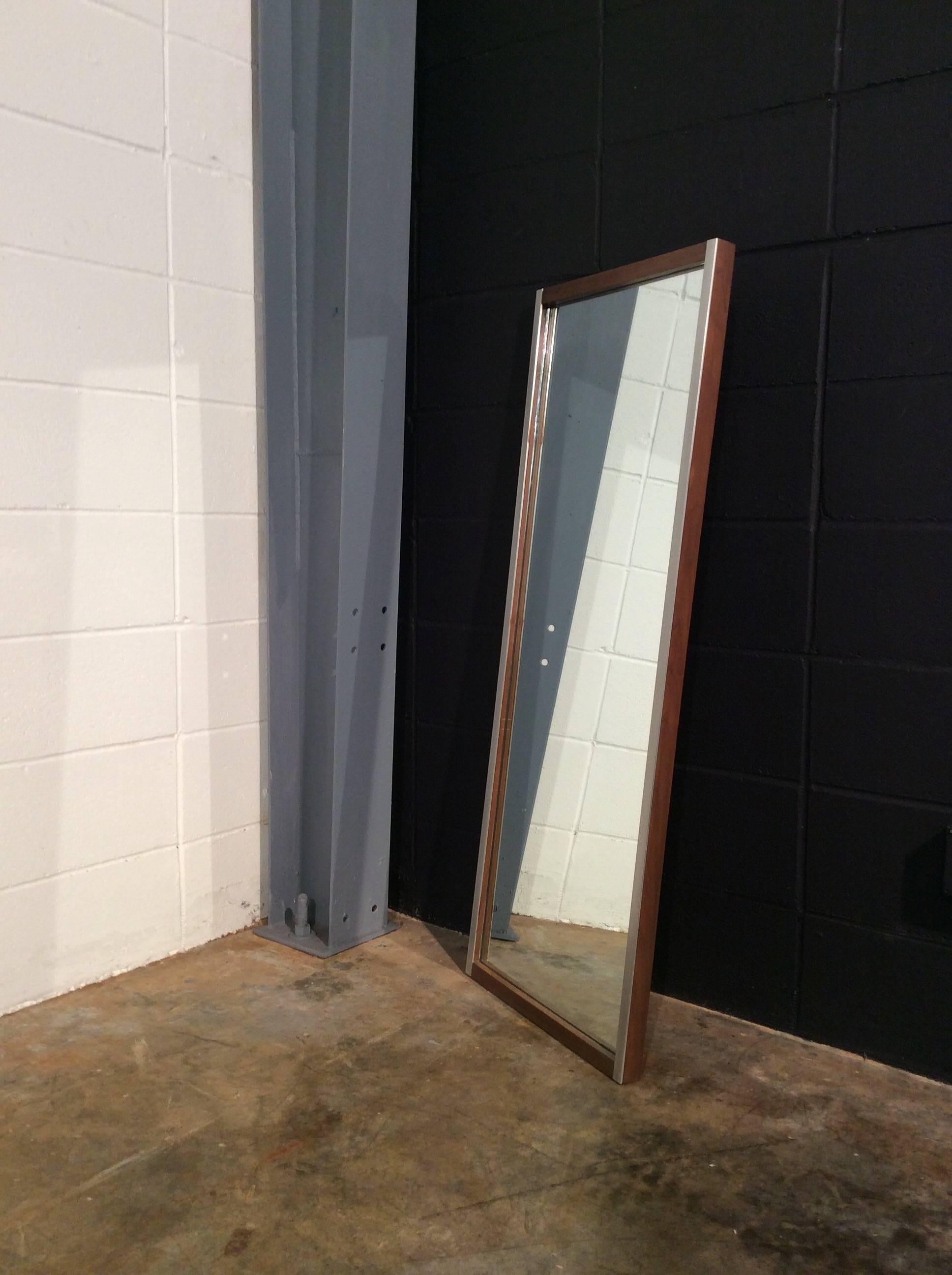 Walnut and aluminum mirror by Paul McCobb for Bryce Originals. Produced February 3rd, 1953
the walnut frame is in really good original condition with minimal wear. The aluminum trim is secured tightly with only minimal surface wear. The mirror