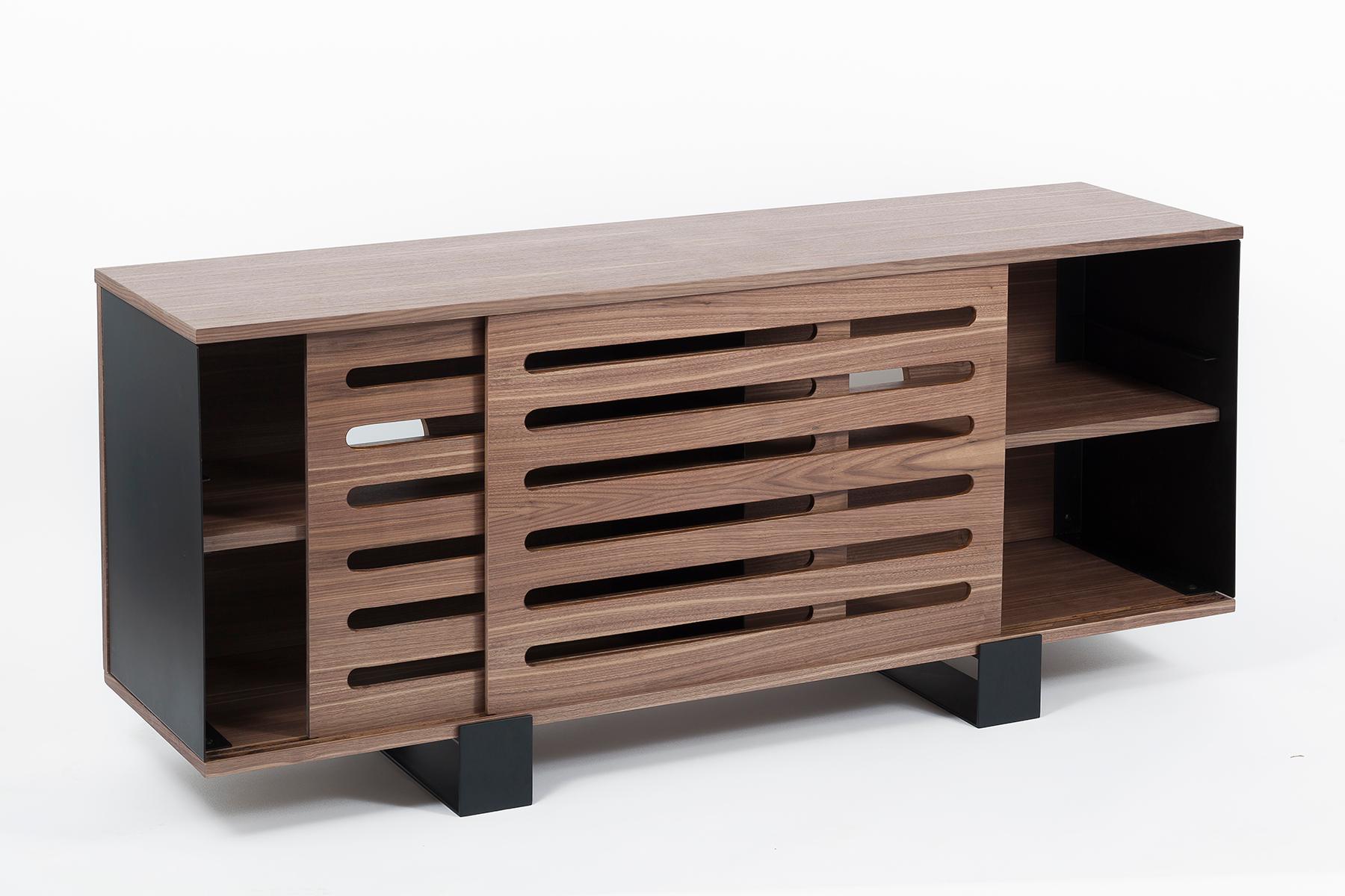 With its elegant sliding doors in american walnut, its smooth steel side panels, and its rich walnut shelves and tabletop, the Mayet Sideboard combines elegance and functionality. Its vast shelves can house your dishes and silverwear, or your books