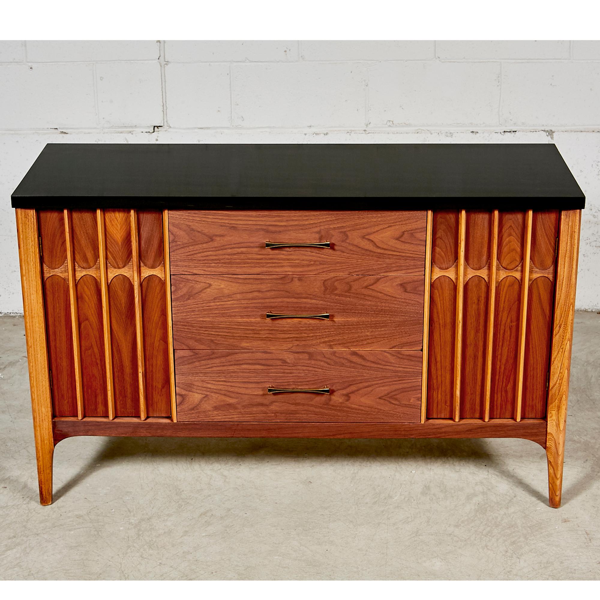 Vintage 1960s walnut wood and black painted top credenza from the Brasilia line of furniture. The credenza has three drawers for storage with additional side shelving. Newly refinished condition.