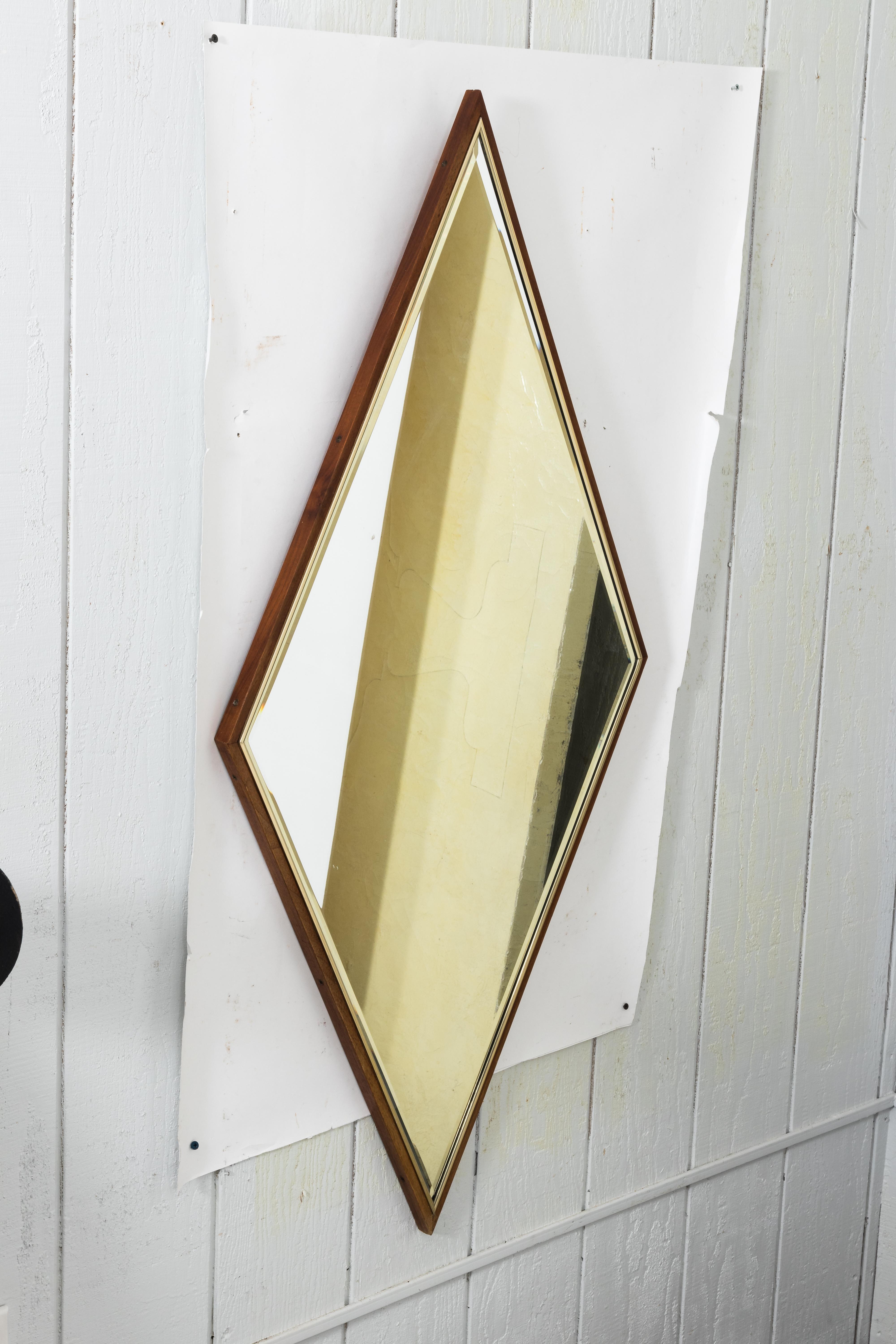 Walnut and brass diamond shaped mirror with bevelled edges, circa 1960s.
