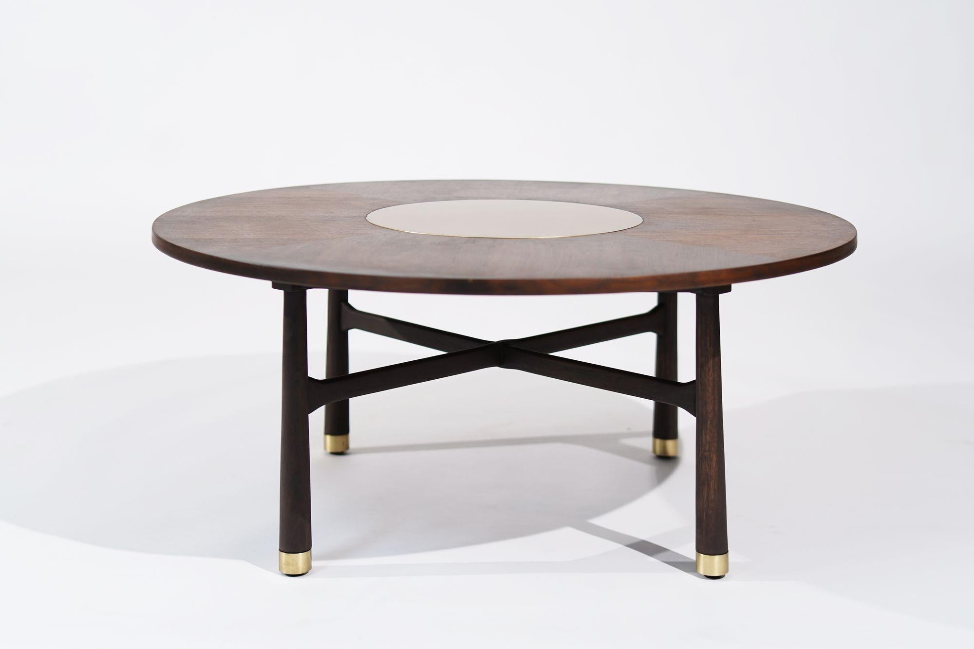 Elevate your space with our restored vintage walnut and brass coffee table by Harvey Probber, circa 1950s. Meticulously refurbished by Stamford Modern, it boasts mid-century charm with brass sabots and a distinctive circular insert. This iconic