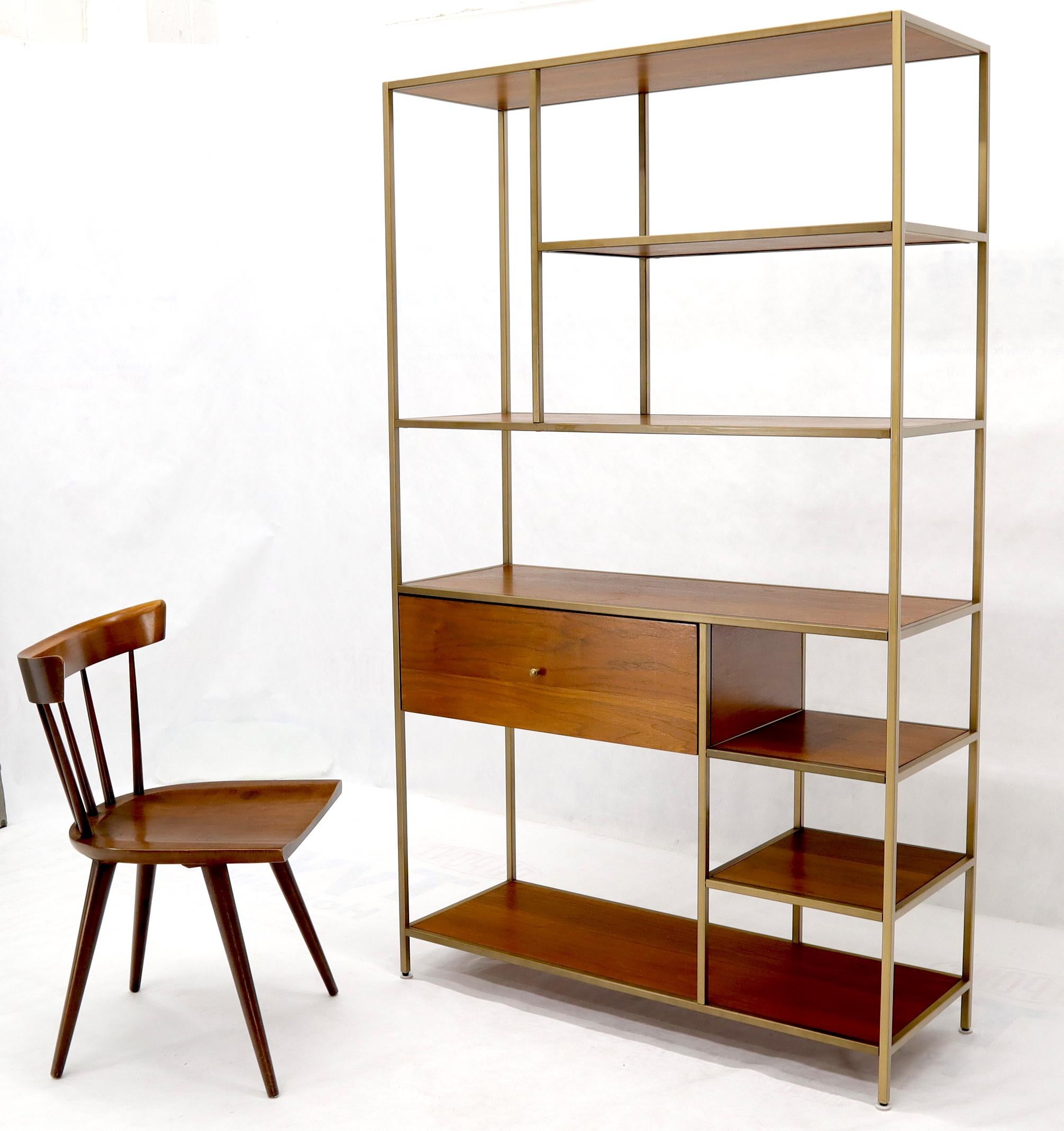 Mid-Century Modern style walnut and brass staggered étagère shelving unit. One deep drawer compartment.