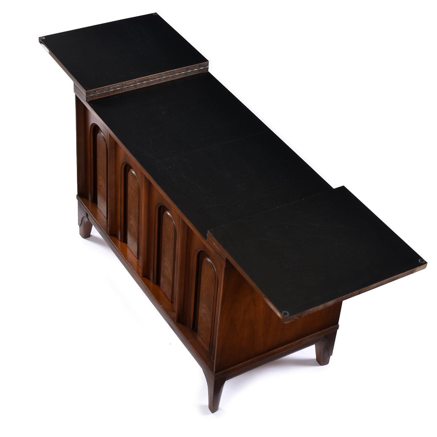 Mid-Century Modern compact expanding top cabinet with ample interior storage. This versatile walnut and burl cabinet is finished on the back side. The back looks identical to the front. Flip one or both of the leaves to lengthen the table top. The