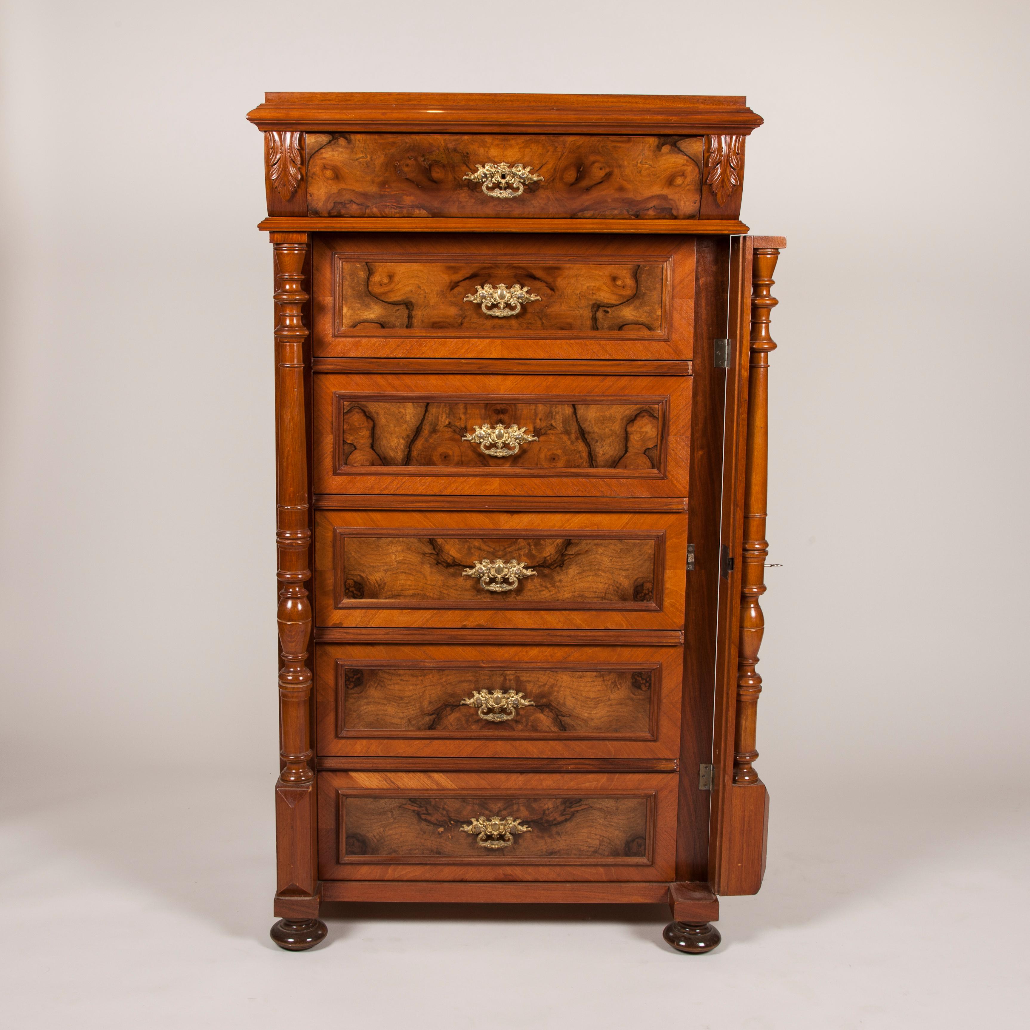 A walnut and burr walnut chest of drawers with ormolu mounts and locking pilaster, six graduating drawers.
