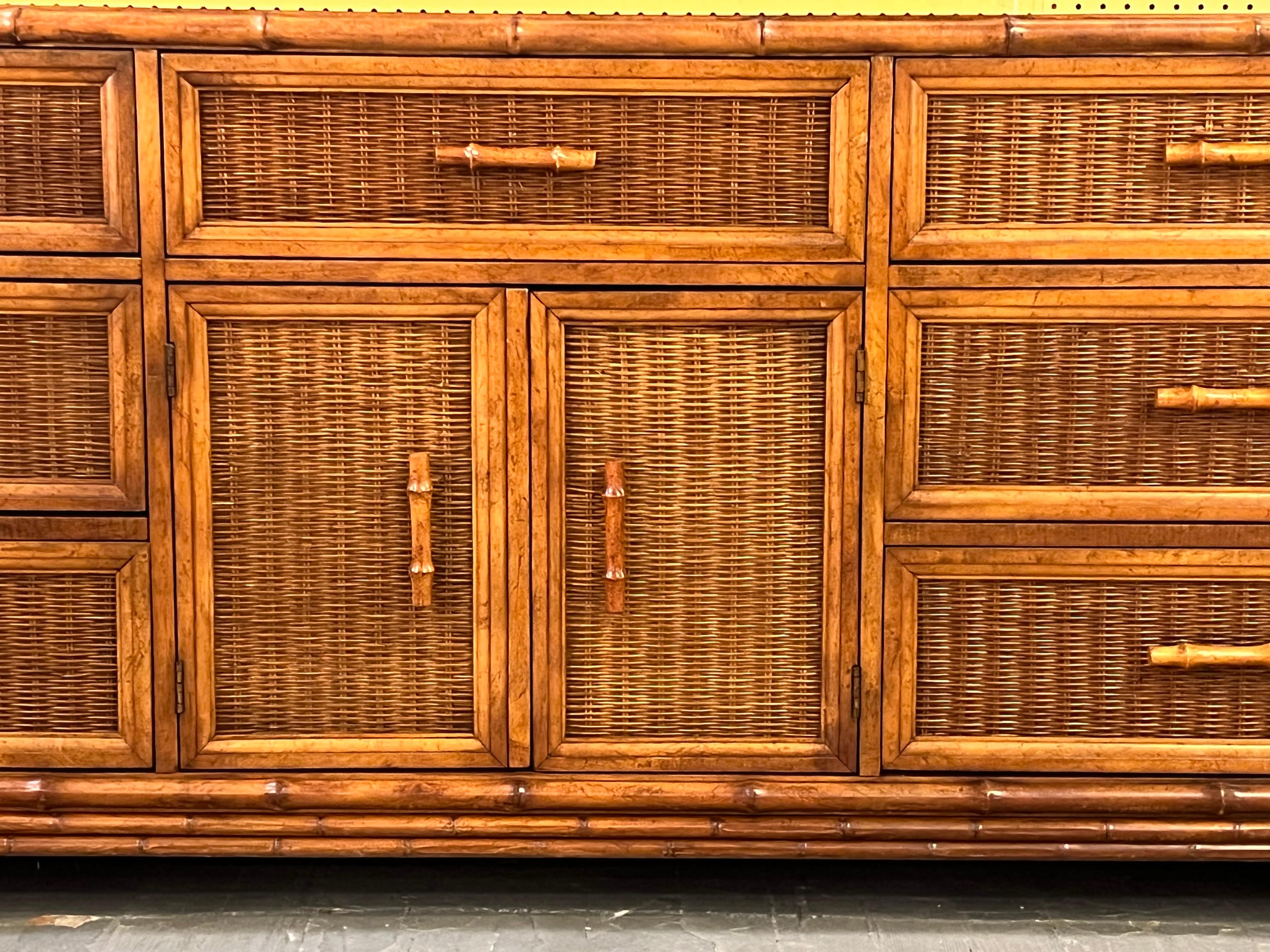 Dresser made of walnut carved to look like bamboo and cane rattan on the drawers and sides.
This dresser features 3 drawers on each side, 1 on the middle top. The 2 doors in the middle open on 2 drawers.
A matching tallboy is available.

Utilizing