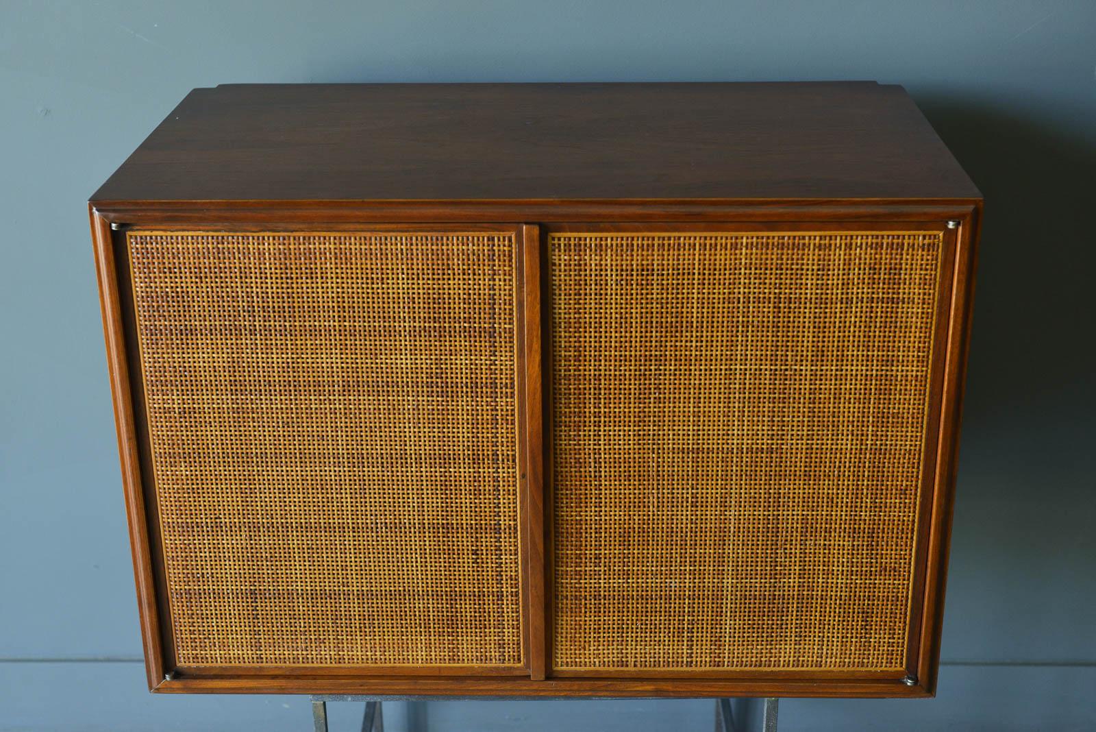 Walnut and cane floating cabinet, ca. 1955. Gorgeous walnut and cane floating cabinets or side table/nightstand. This beautiful piece has a custom bespoke made bracket that will allow you to float on the wall and sits flush when easily installed.