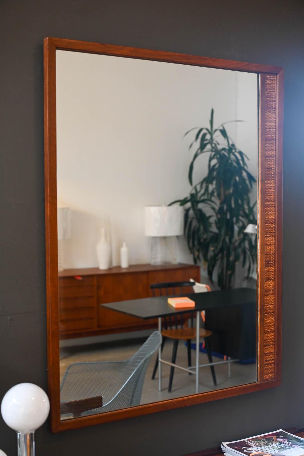 Walnut and Cane Wall Mirror by Drexel, ca. 1965.  Original walnut and cane mirror by Drexel.  Unique aysemmetrical cane detail on one side, can be hung vertical or horizontal.  Very good original condition there are no chips in the glass and it is