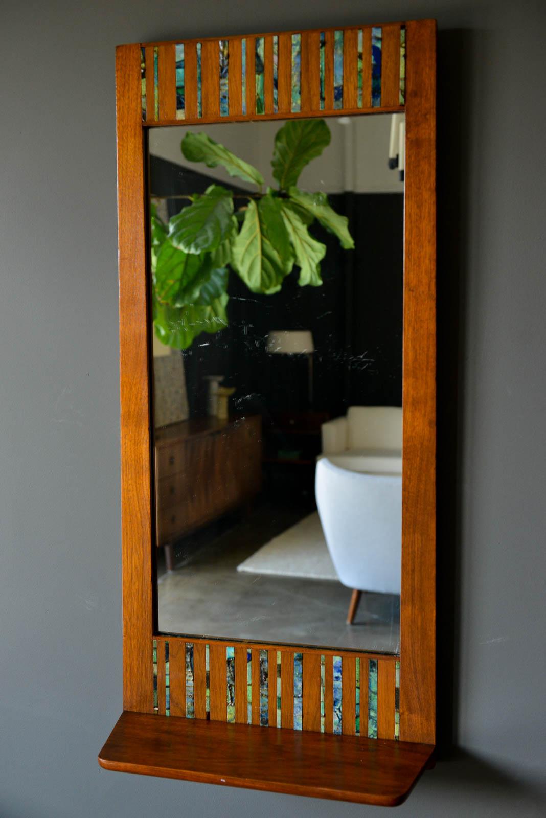 Walnut and ceramic tile floating shelf mirror by Harris Strong, circa 1965. Beautiful walnut frame with original mirror and handmade blue/green/aqua ceramic inlay tiles. Excellent original condition. Slight patina to the mirror, wood is excellent