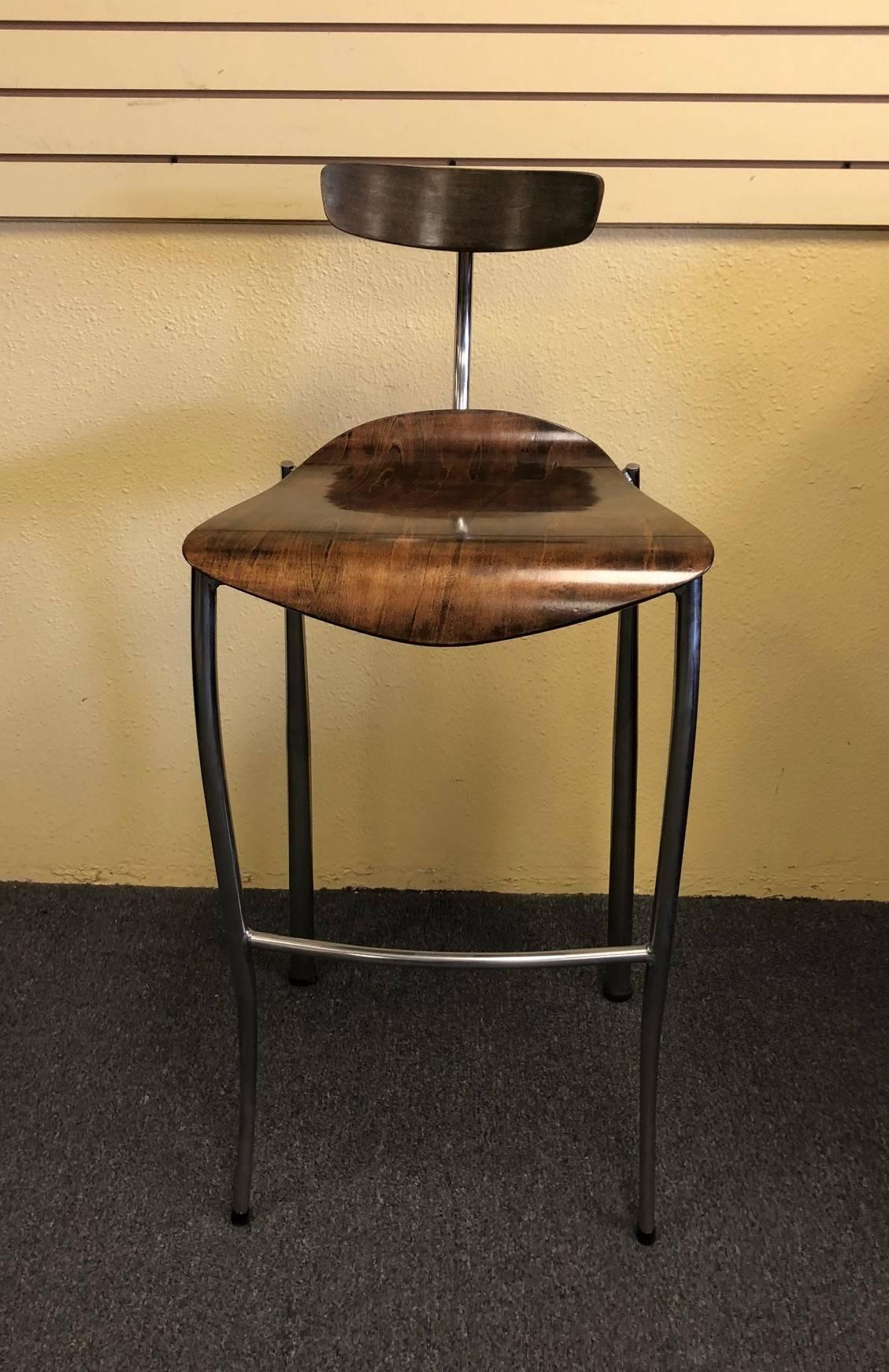 A very stylish and functional pair of bent walnut wood and chrome bar stools made in France, circa 1970s.