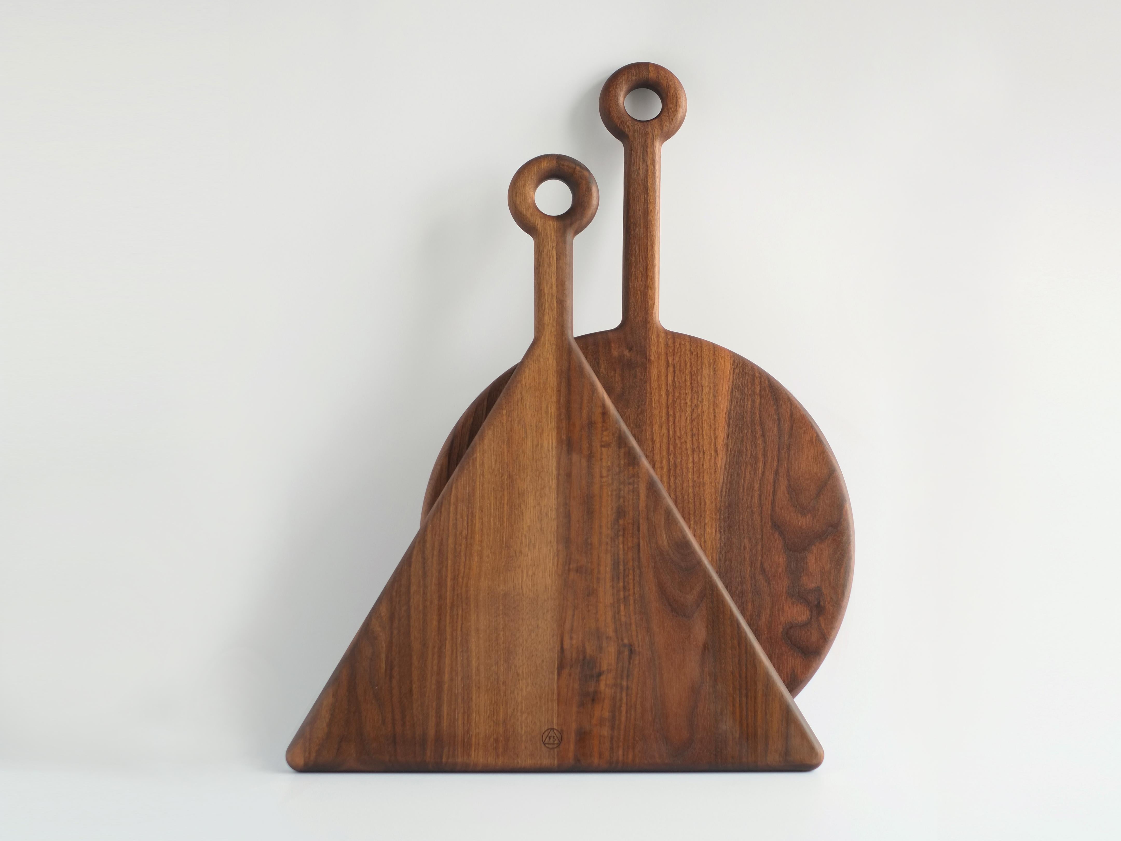 These American walnut and curly cutting boards are as beautiful displayed on the wall when not in use as they are when serving cheeses and hor d'oeuvers. 

The large, donut-like hanging hole allows each Plank to rest on almost any hook or nail,