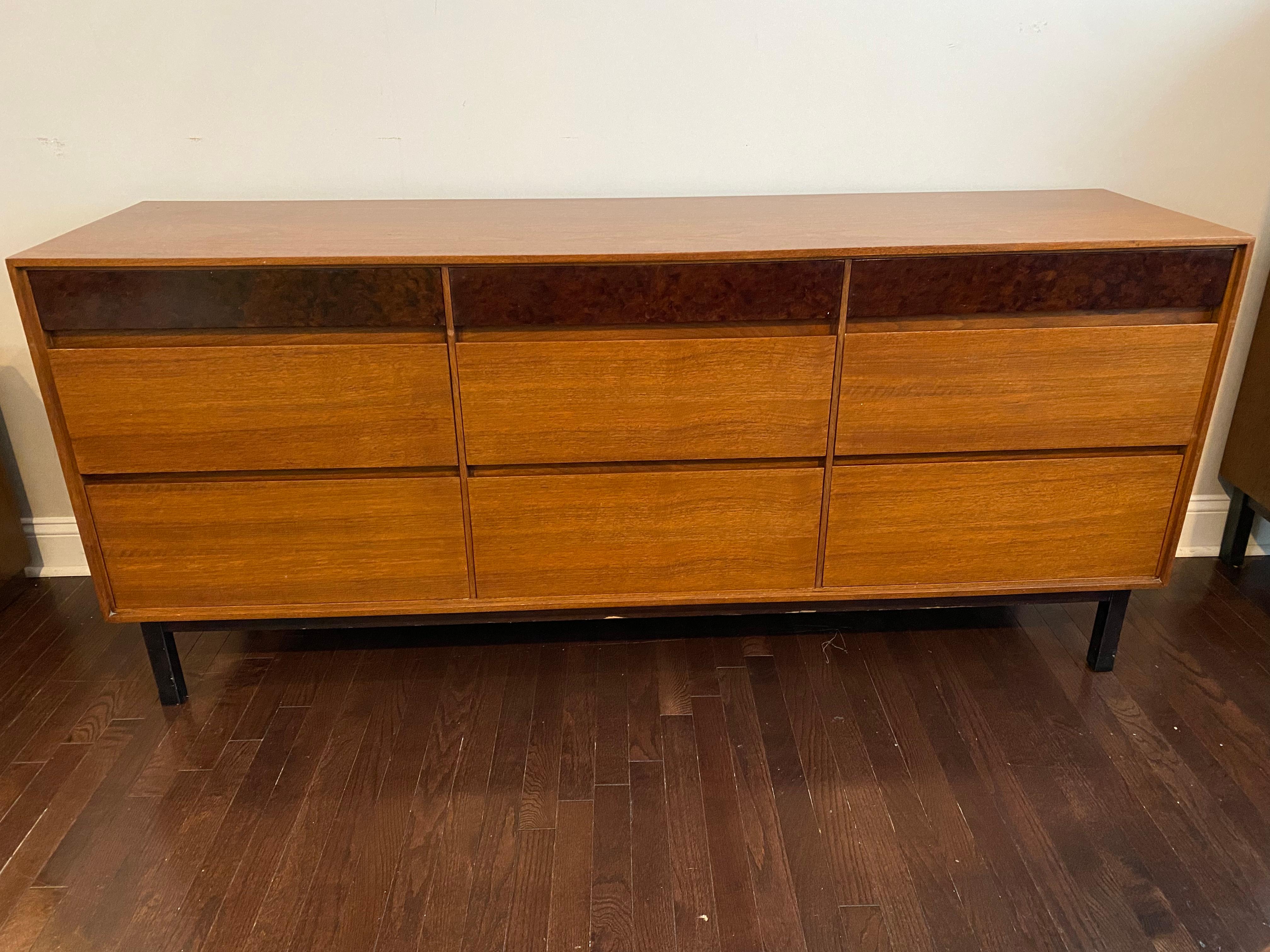 Walnut and Burl Mid-Century sideboard by John Stuart for Mt. Airy Furniture Co. Beautiful walnut sideboard with decorative-painted burl on top drawers. Three small drawers at top with six large drawers at bottom with black base and legs. Beautiful