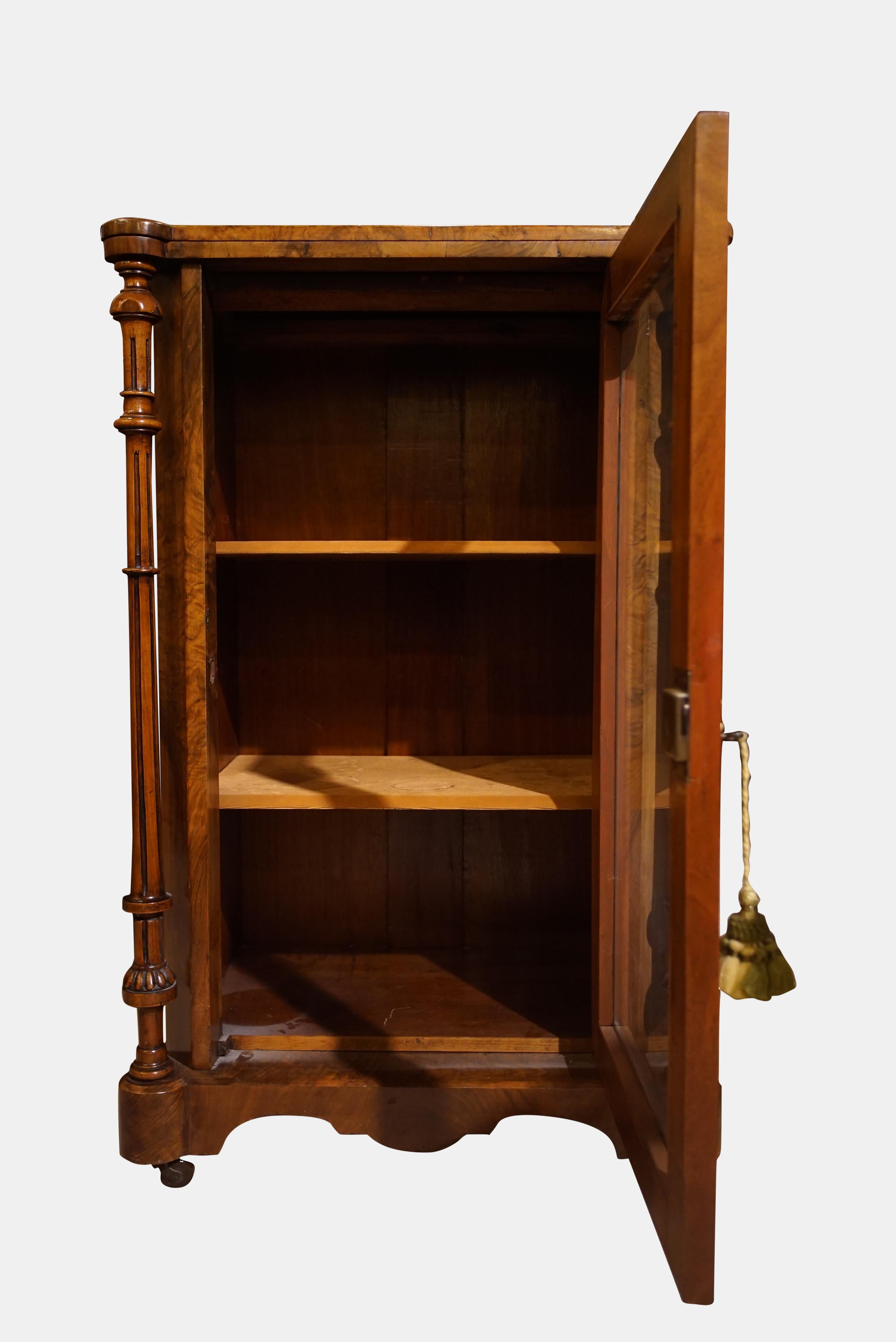 A walnut and inlay music cabinet with brass gallery and key,
circa 1860.
    