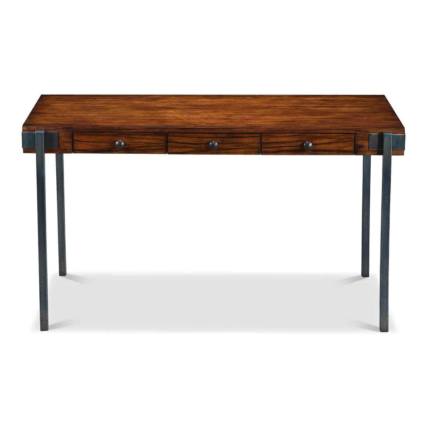 A walnut and iron three-drawer desk, the top of the desk is crafted in walnut and has three drawers, it sits on clean-lined iron legs. 

Dimensions: 54