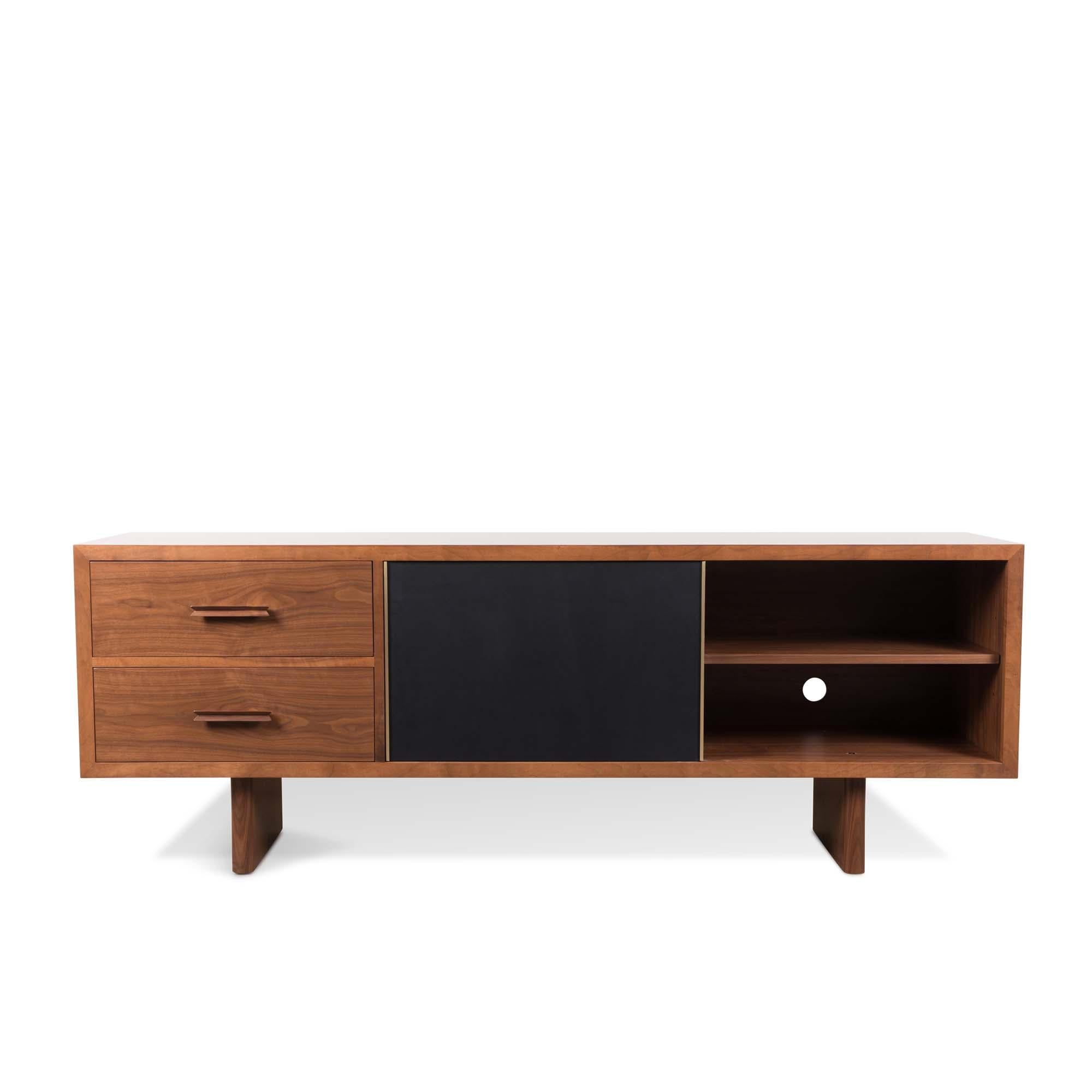 The inverness media cabinet features two drawers with solid carved handles, adjustable shelves, grommet holes and a sliding leather door with a solid brass handle. Available in American walnut or white oak. Wall-mounted version available. Specify at