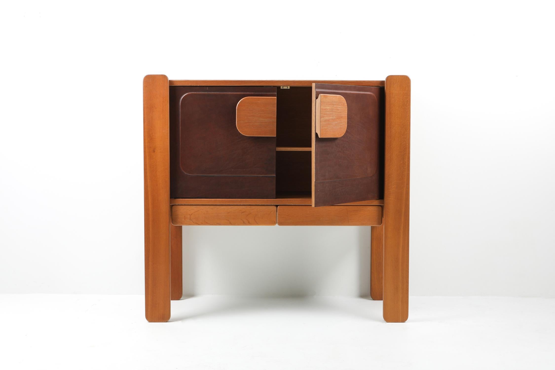 Postmodern storage piece with leather door panels, Belgium, 1970s
Well executed cabinet in oak and leather.

 