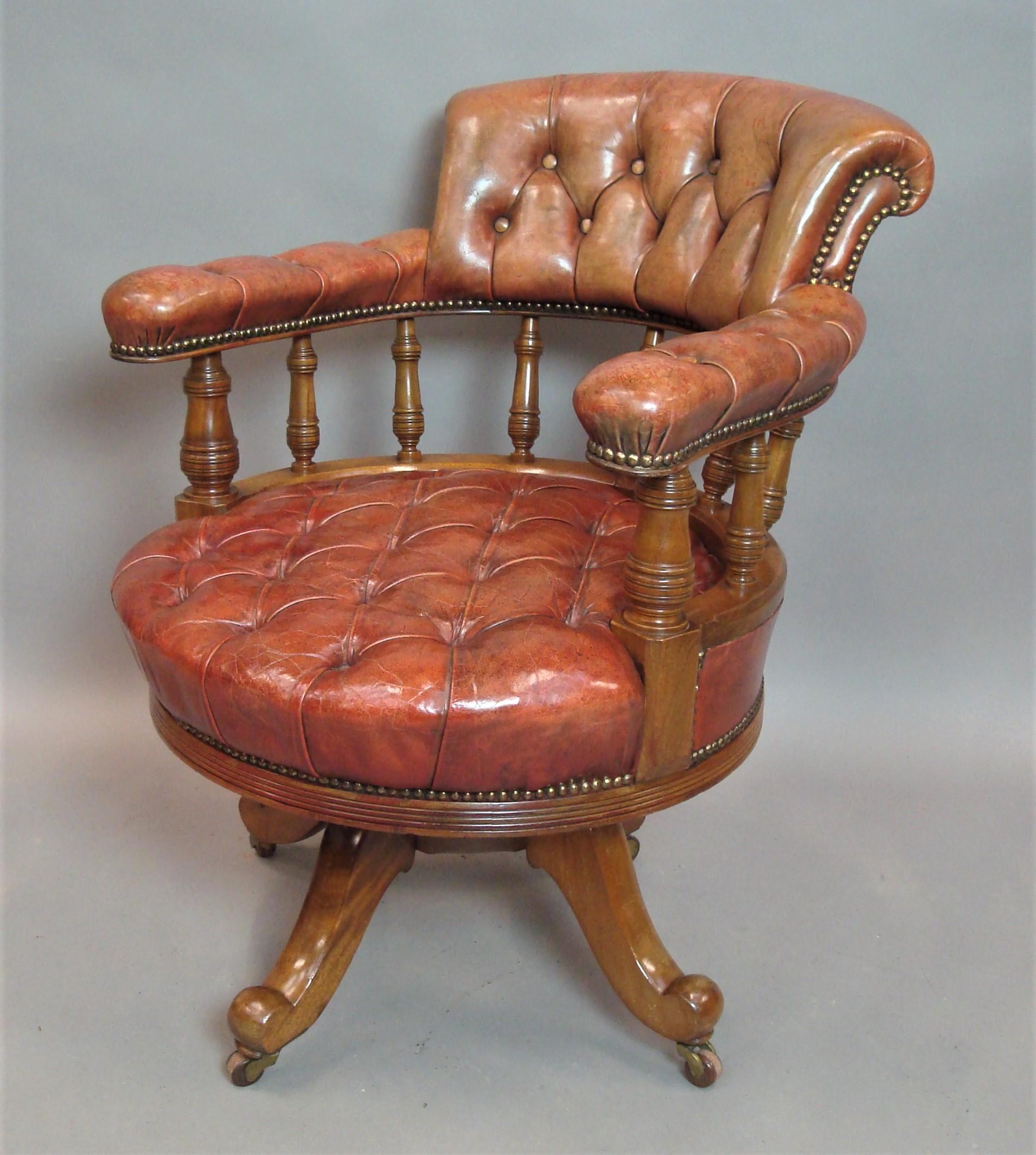 Good 19th century walnut and leather revolving desk chair of generous proportions; the horseshoe shaped back with a raised, curved backrest and swept arms supported on ring turned tapering supports. The substantial padded circular seat with a reeded