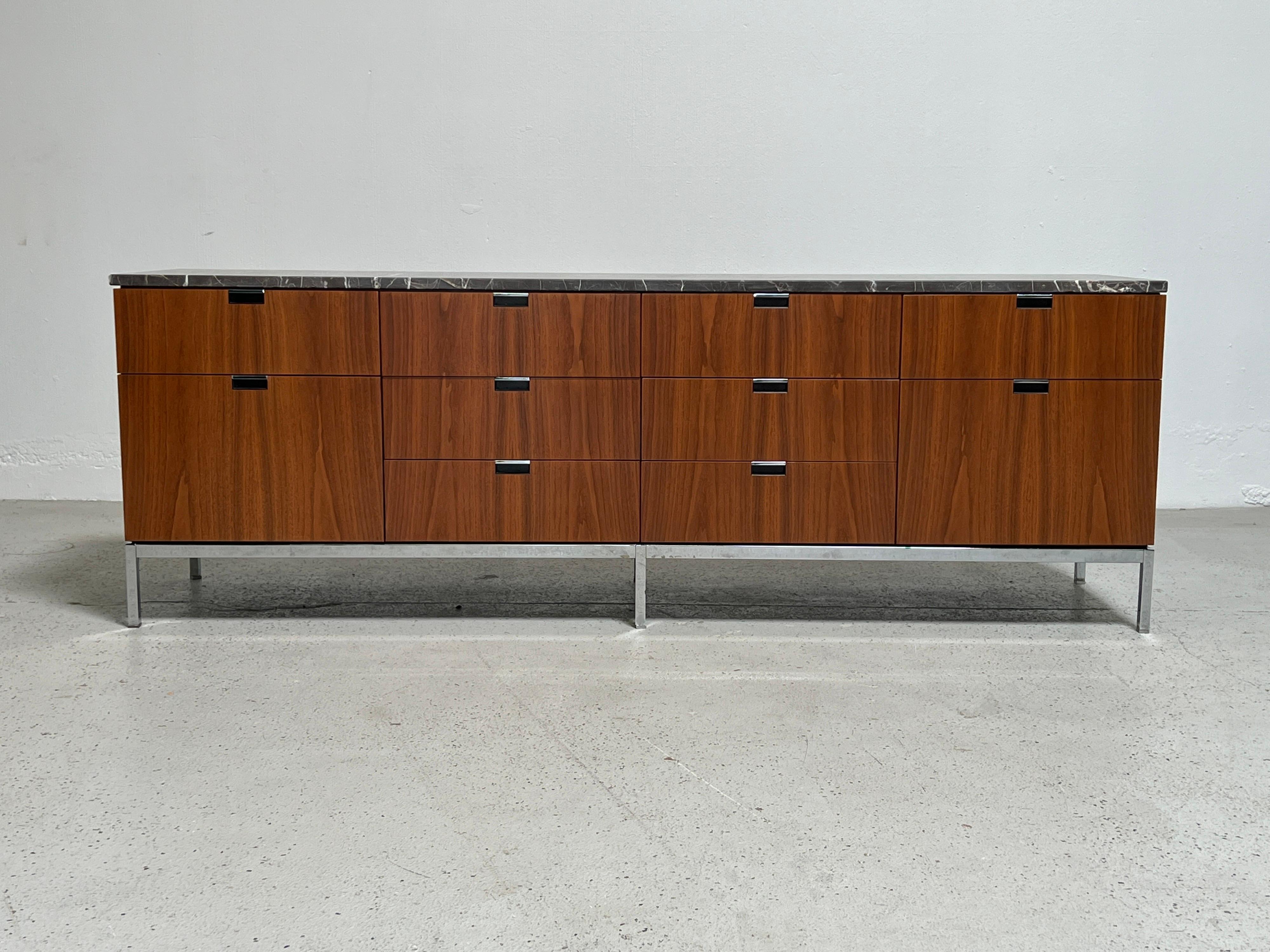A Florence Knoll for Knoll walnut credenza with finished back and marble top.