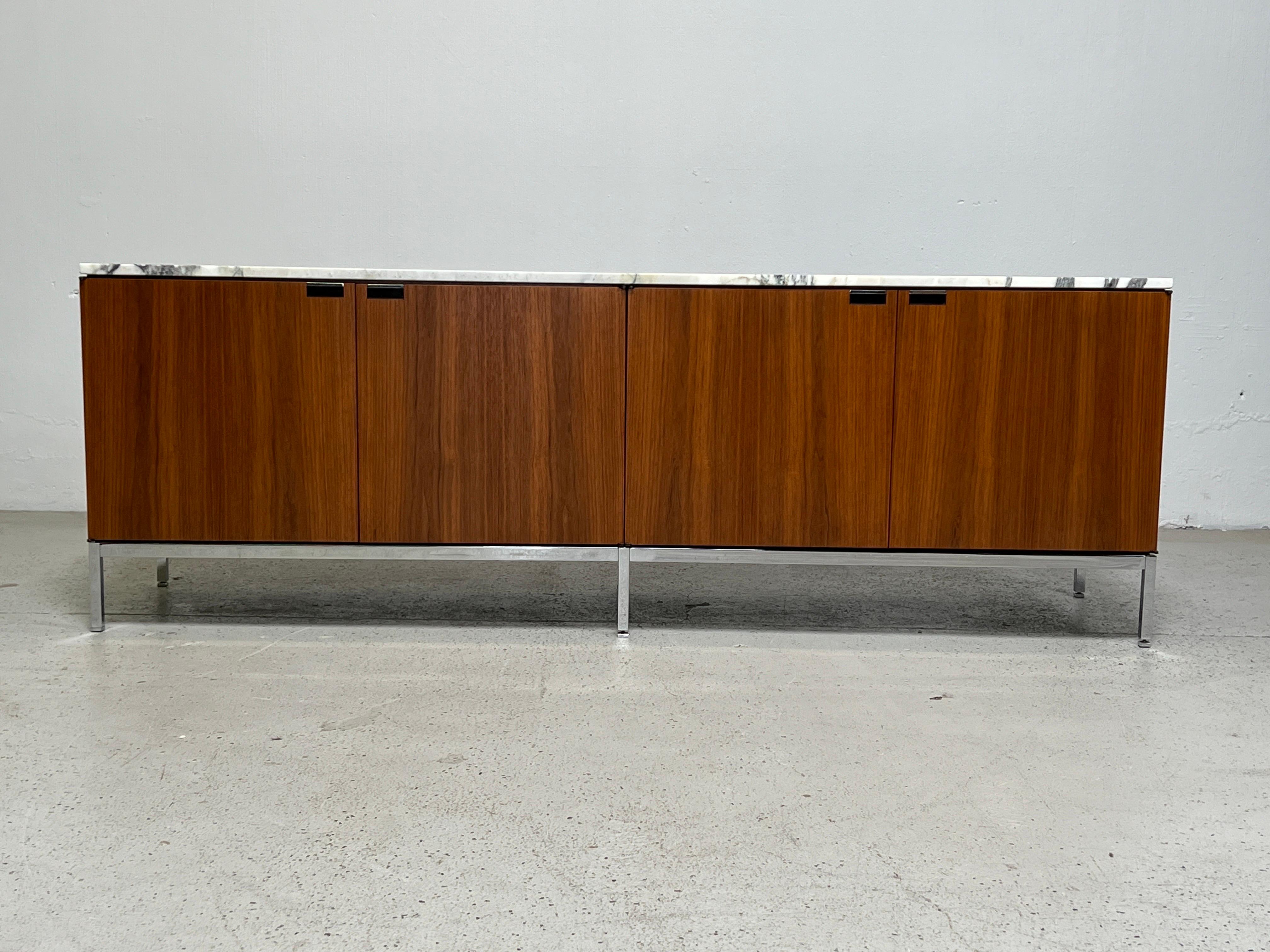 A Florence Knoll for Knoll walnut credenza with finished back and marble top.