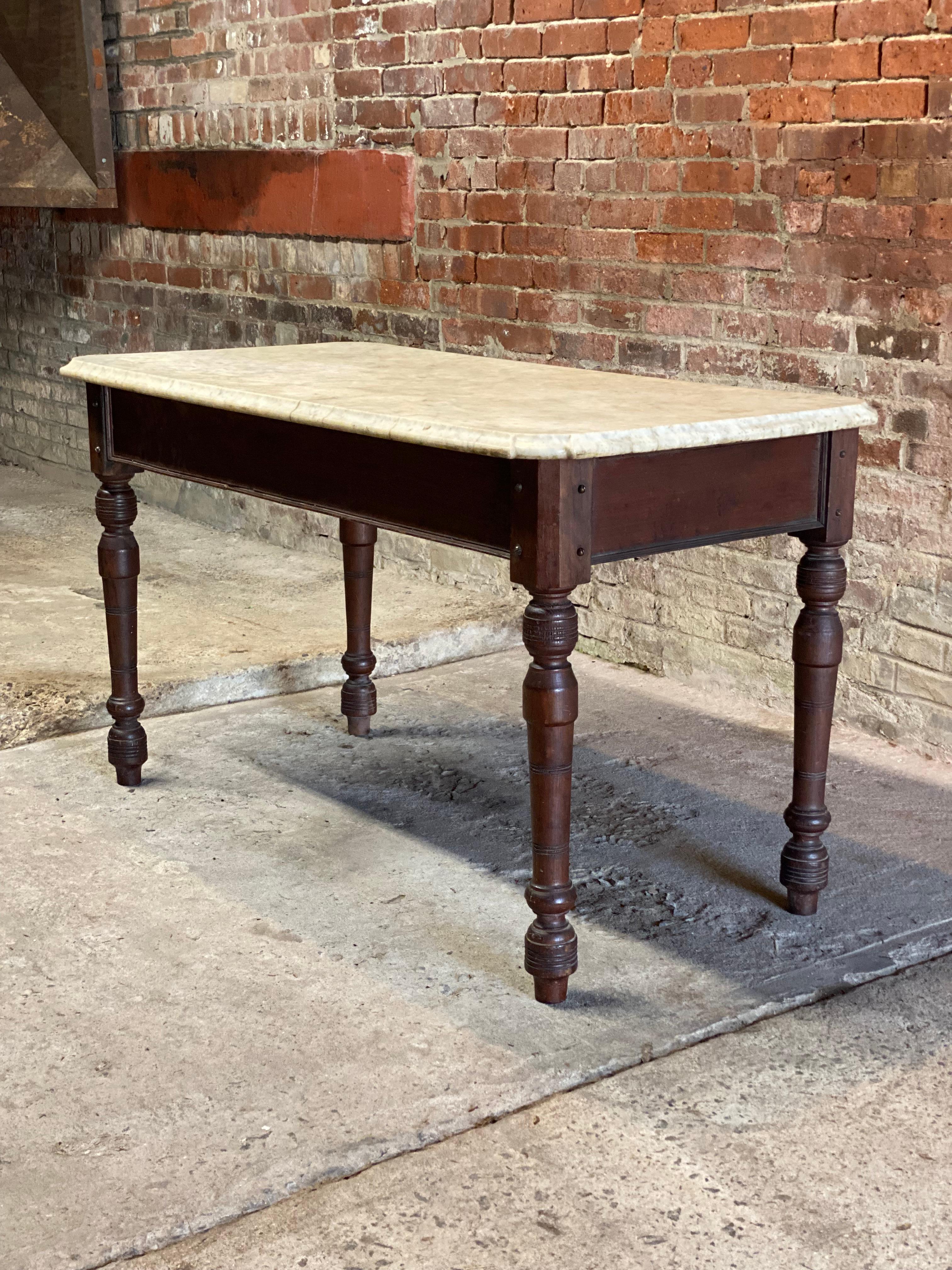 Late Victorian era solid walnut base farm table with a nicely shaped and rounded corner white marble top. Featuring dovetailed corners and middle stretcher construction, finely turned legs and recessed panels adorn the apron. Circa 1870-1890. 

The