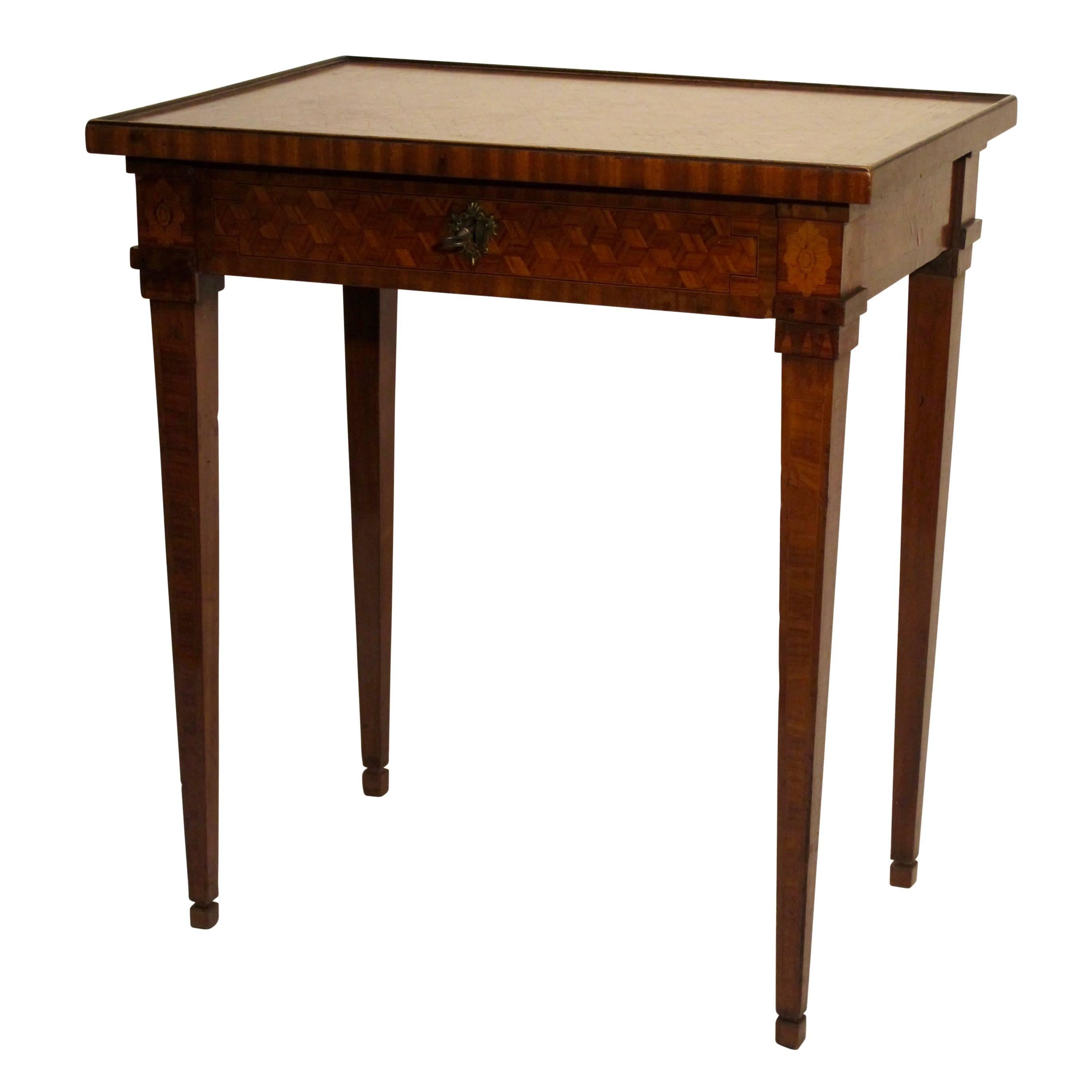 Exceptional walnut and mixed fruitwood table with inlay parquetry design and beautiful detailing, having a single center drawer and standing on tapering legs. In superb original condition, France, late 18th century, circa 1780.