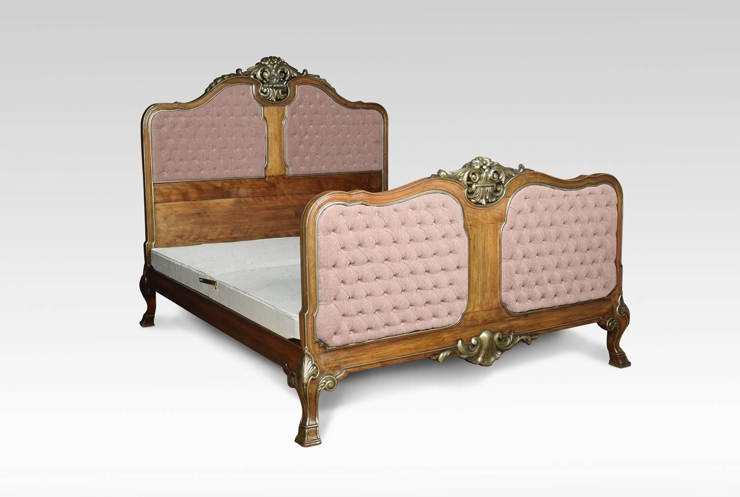 Walnut and parcel-gilt king size bed with scrolling carved floral motifs, surrounding inset deep buttoned upholstered panels. All raised up on leaf volute capped legs.
This bed will fit a standard king size mattress.
Dimensions:
Height 62.5