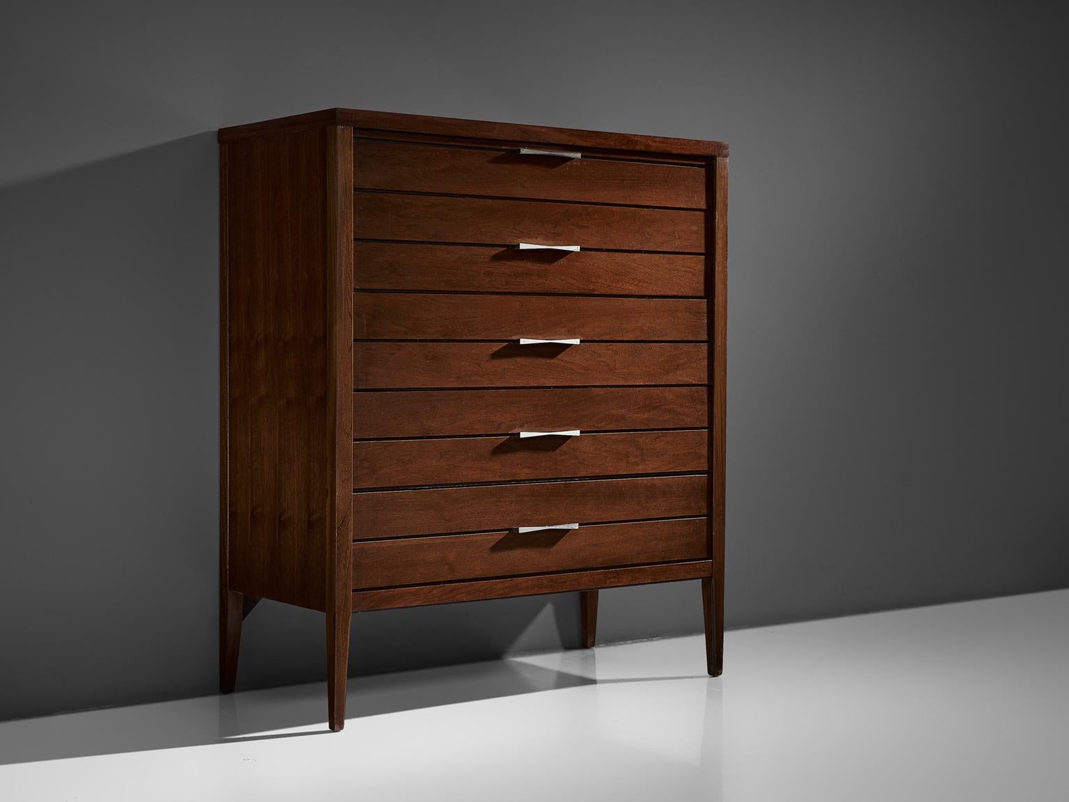 Chest of drawers, walnut, rosewood and metal, United States, 1950s.

This chest of drawers features strong traits of the functional and modest furniture line of Paul McCobb. The piece features five butterfly handles and beautiful matching butterfly