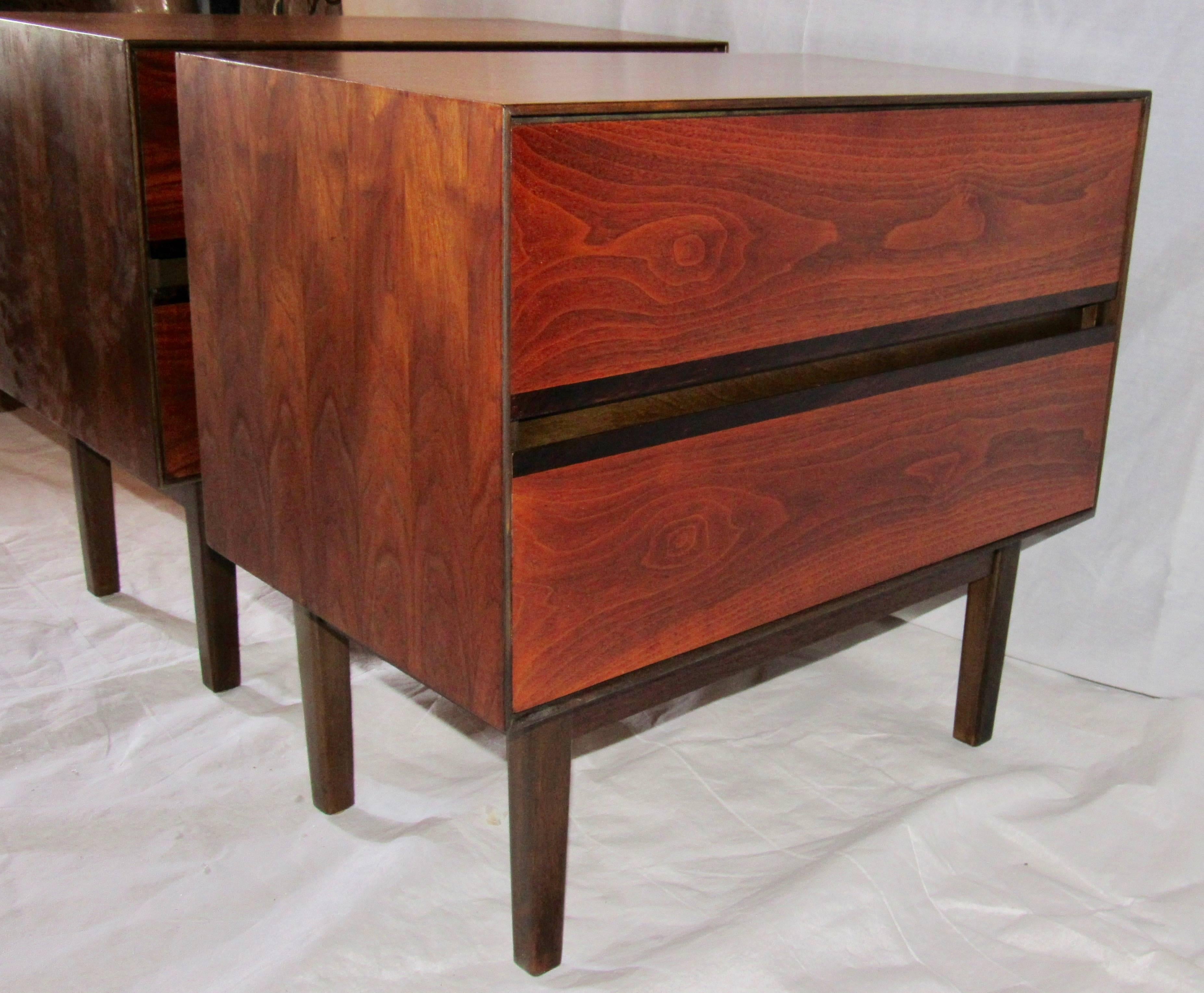 Midcentury pair of nightstands by H. Paul Browning for Stanley’s “Royal American” collection.
This elegant minimal design has two drawers in a walnut frame resting on a recessed four legged base of dark stained maple.
Each drawer has a slim band