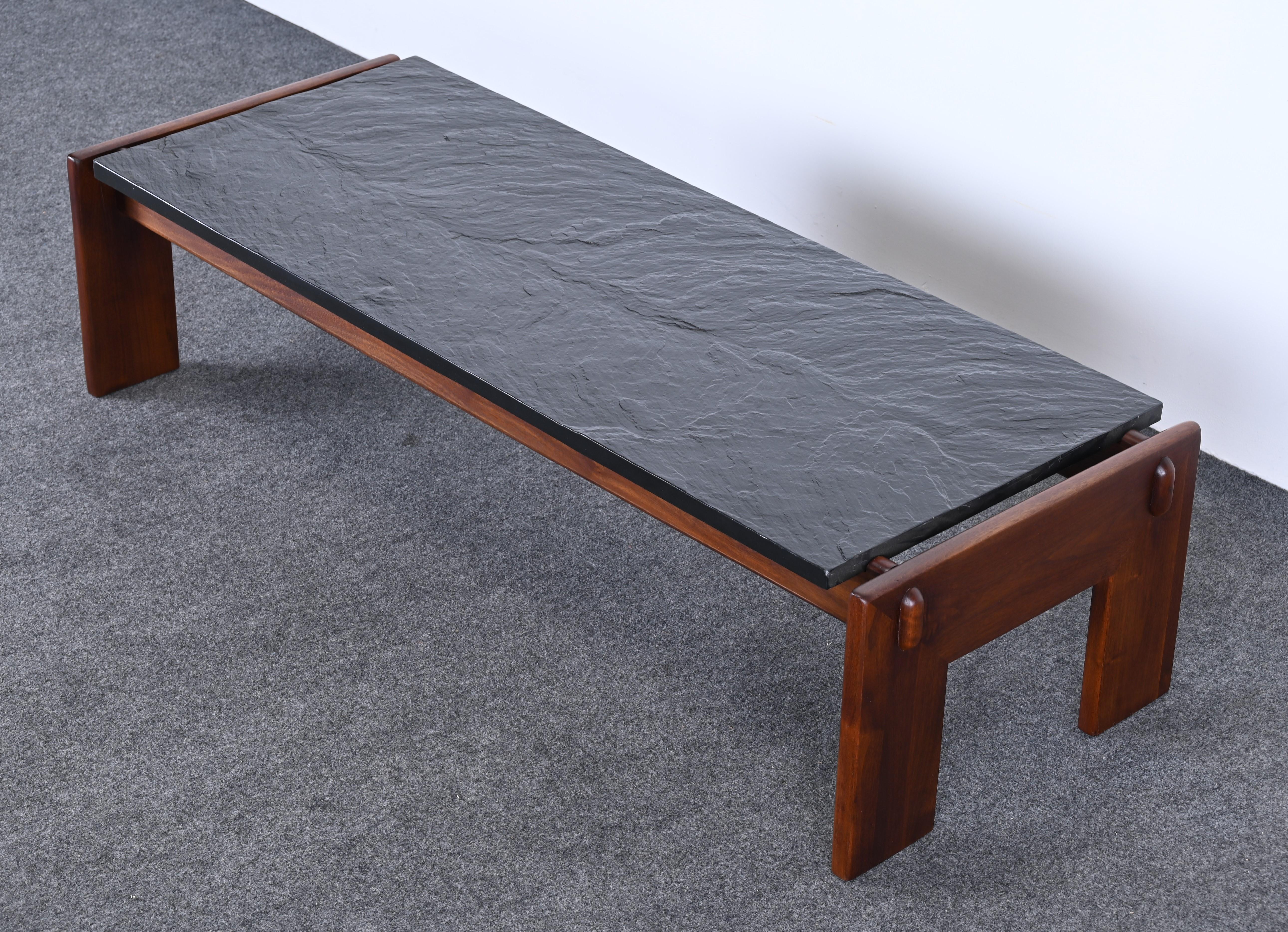 A gorgeous sleek Mid-Century Modern walnut and slate coffee table designed by Adrian Pearsall. This beautiful cocktail table would make a great focal point in any interior. The wood has been expertly refinished and the slate top is in very good