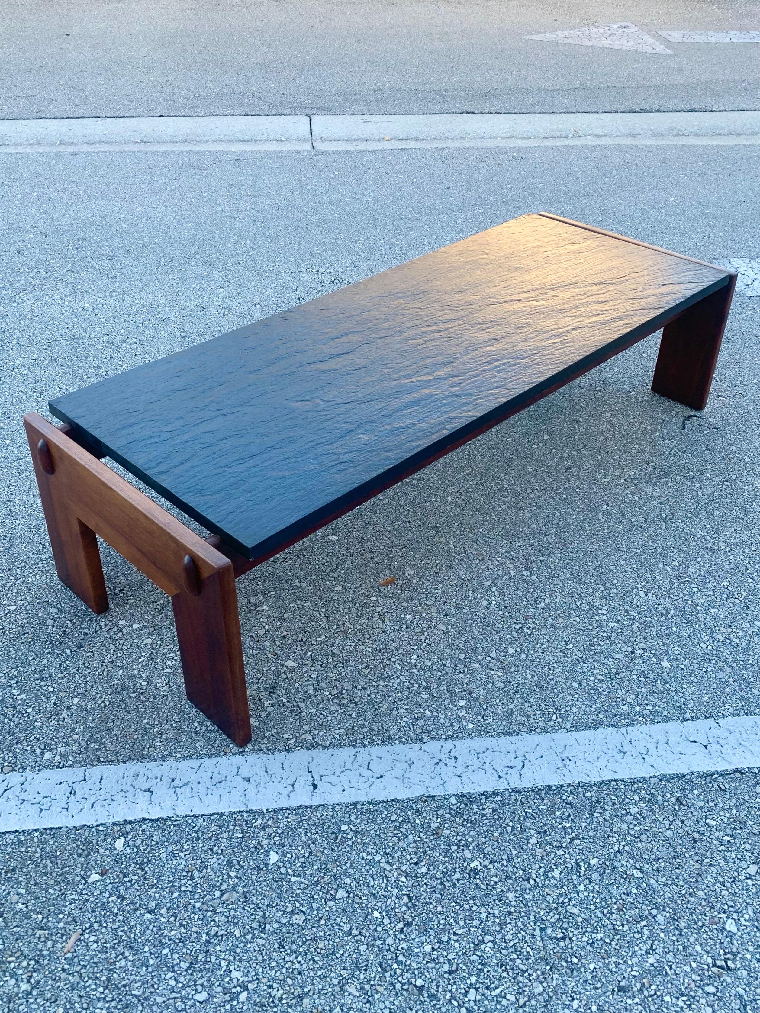 Coffee table by Adrian Pearsall. Solid walnut frame with a black slate top. In stellar condition. Finish has refreshed by a thorough clean and fresh oil. Beautiful grain in wood and slate. Previous owner claimed it was owned by his father who was a