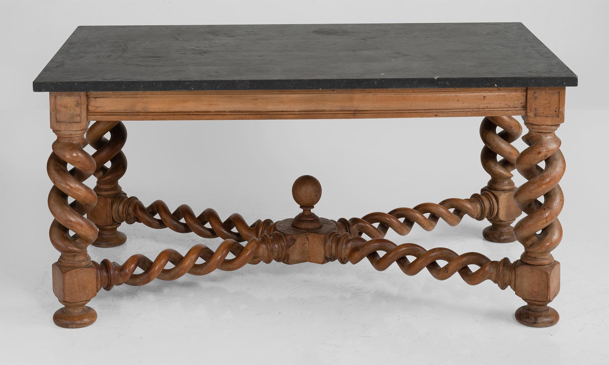 Ornately carved walnut base with polished stone top.

 