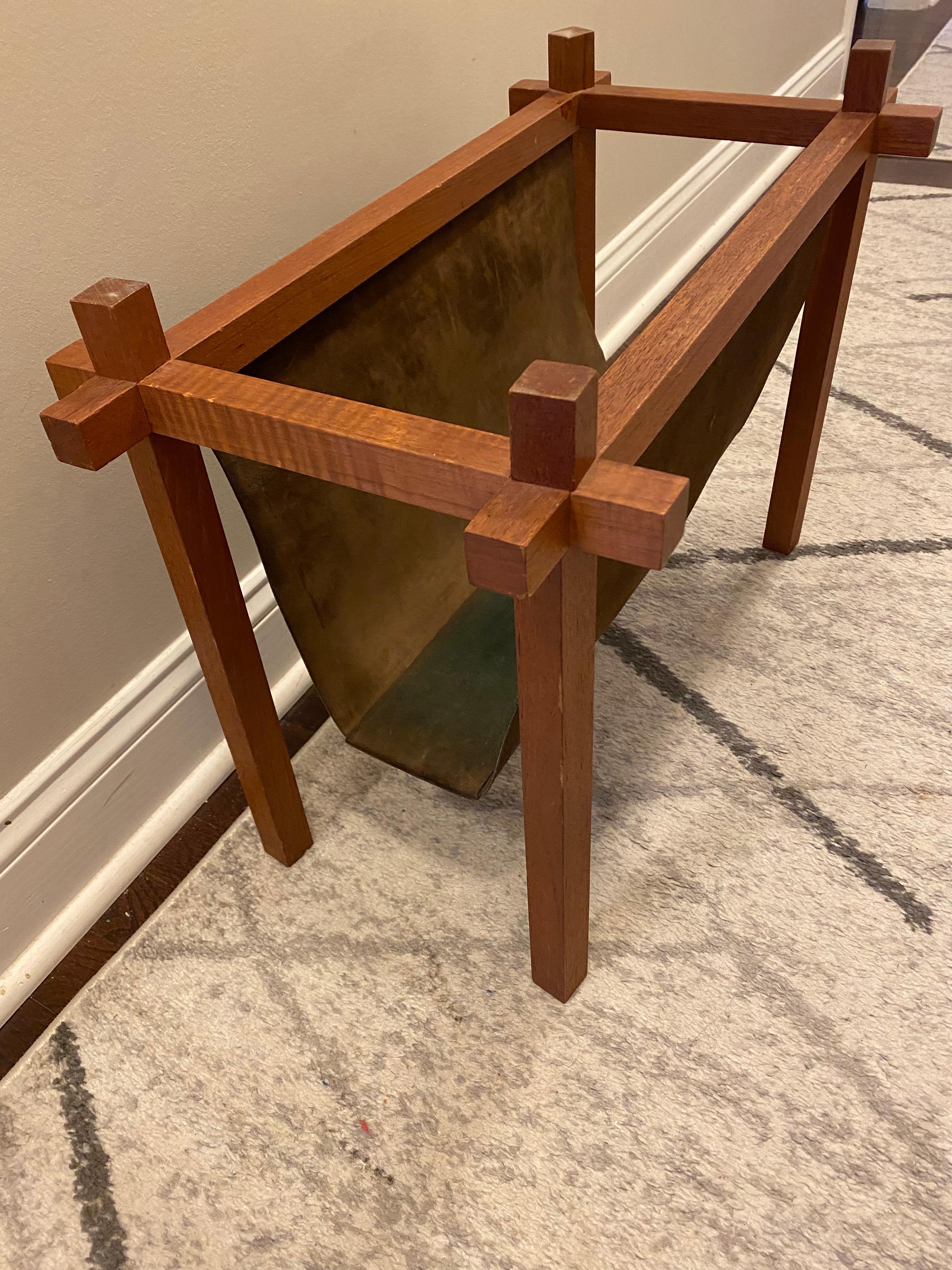 Walnut and Suede Mid-Century Modern magazine rack. Square legs with a chocolate brown suede sling with squared underside.