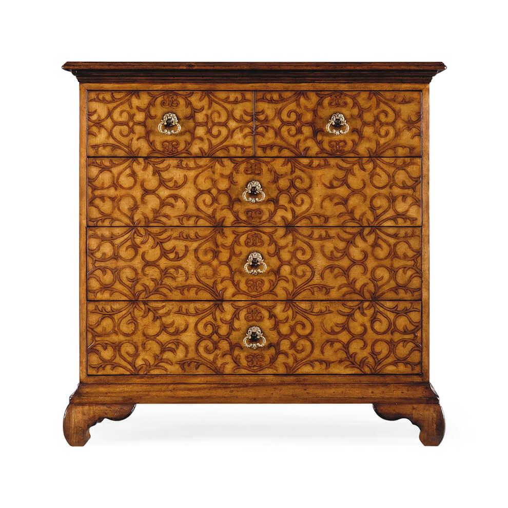 Finely detailed chest of drawers of antiqued walnut with two short drawers and three long drawers, the whole with a contrasting all-over raised veneer design of swirling arabesques, set on Chinese inspired curved bracketed feet. Finely cast brass