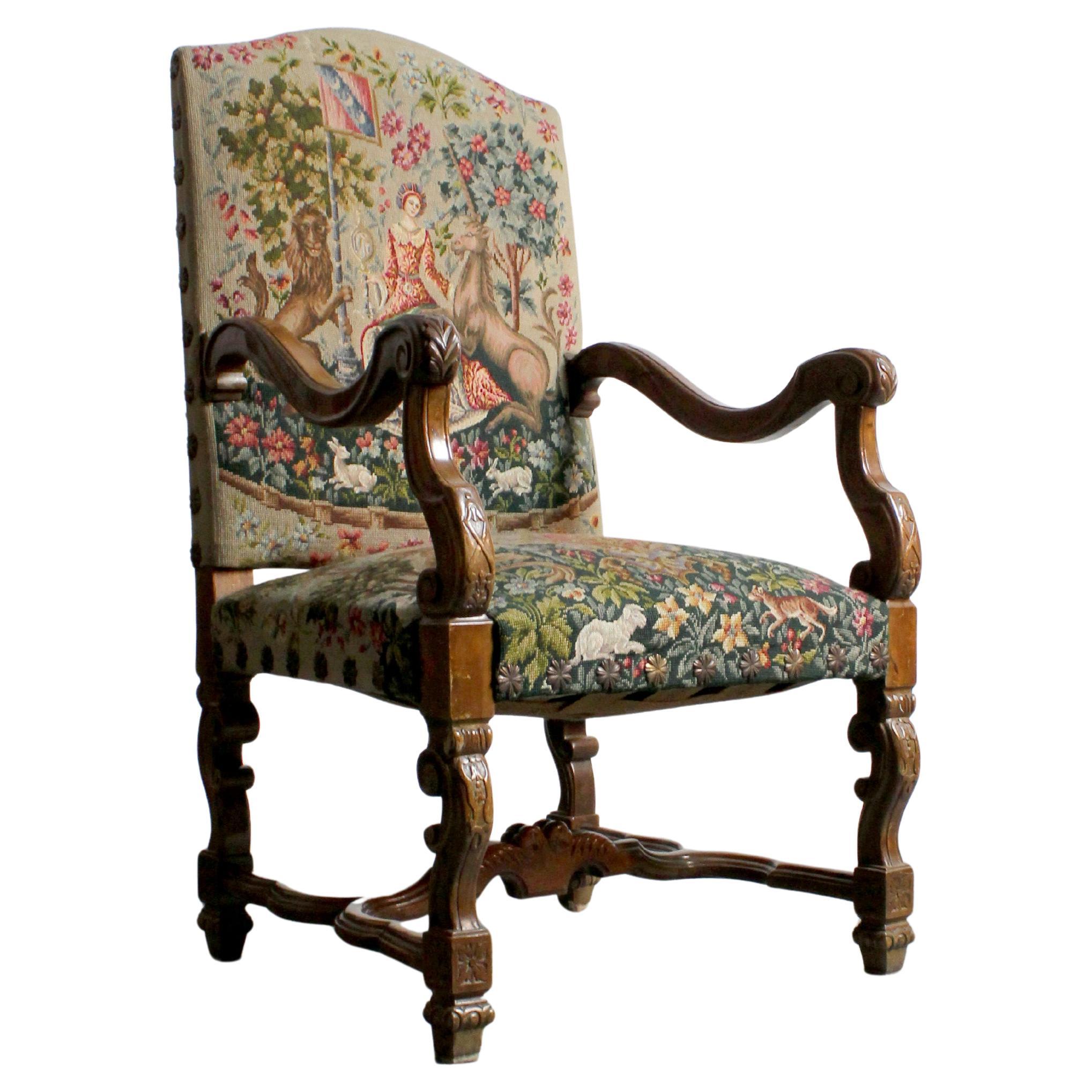 Fauteuil en noyer avec brancard en H et tapisserie brodée au petit point.
